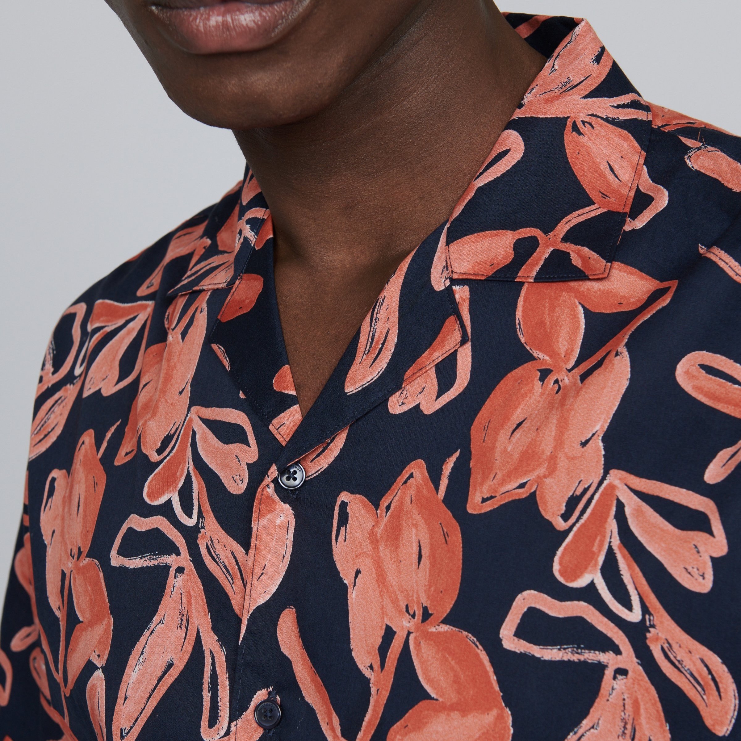 Close View of Model in Matinique Pattern Short Sleeve Shirt in Navy and Orange