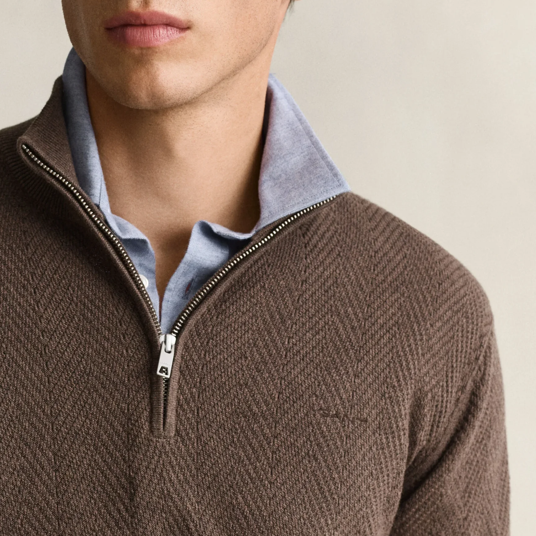 Close View of Model in GANT Herringbone Texture Half Zip in Brown Melange