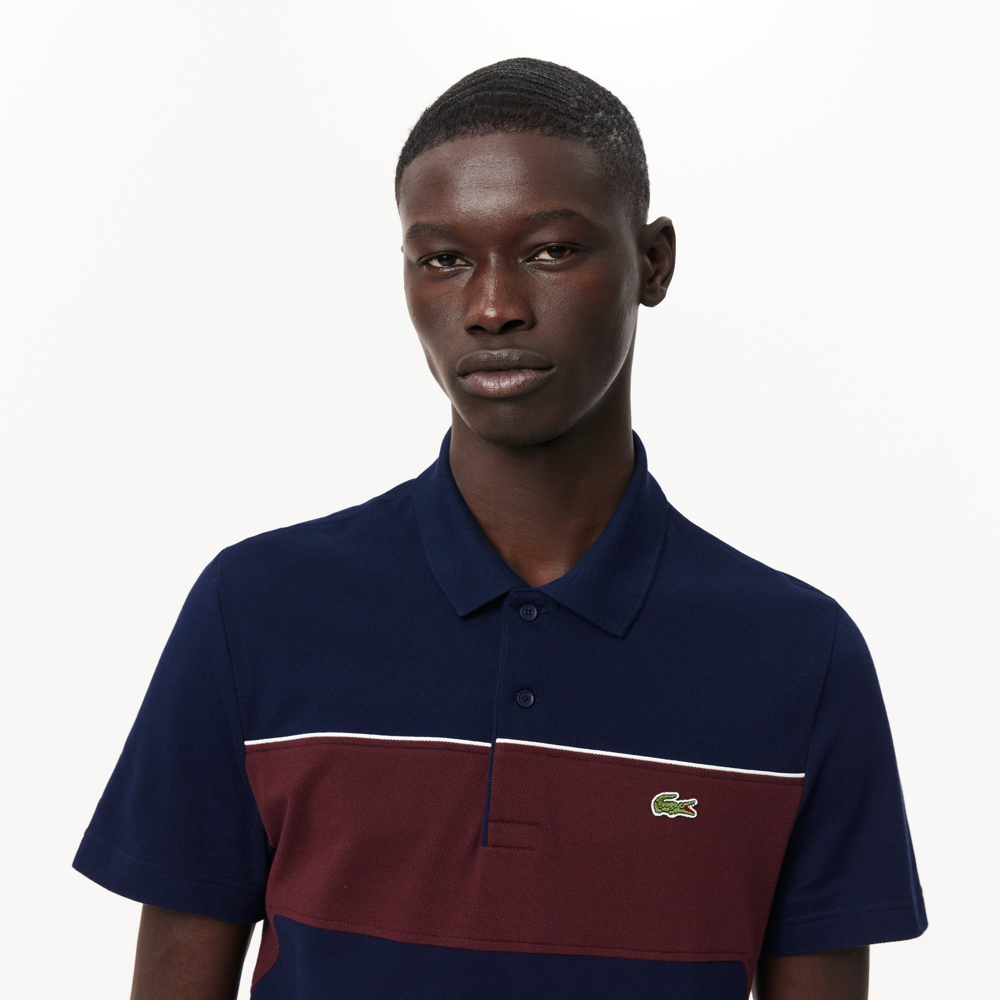Close View of Model in Lacoste Colour Block Polo in Navy and Burgundy