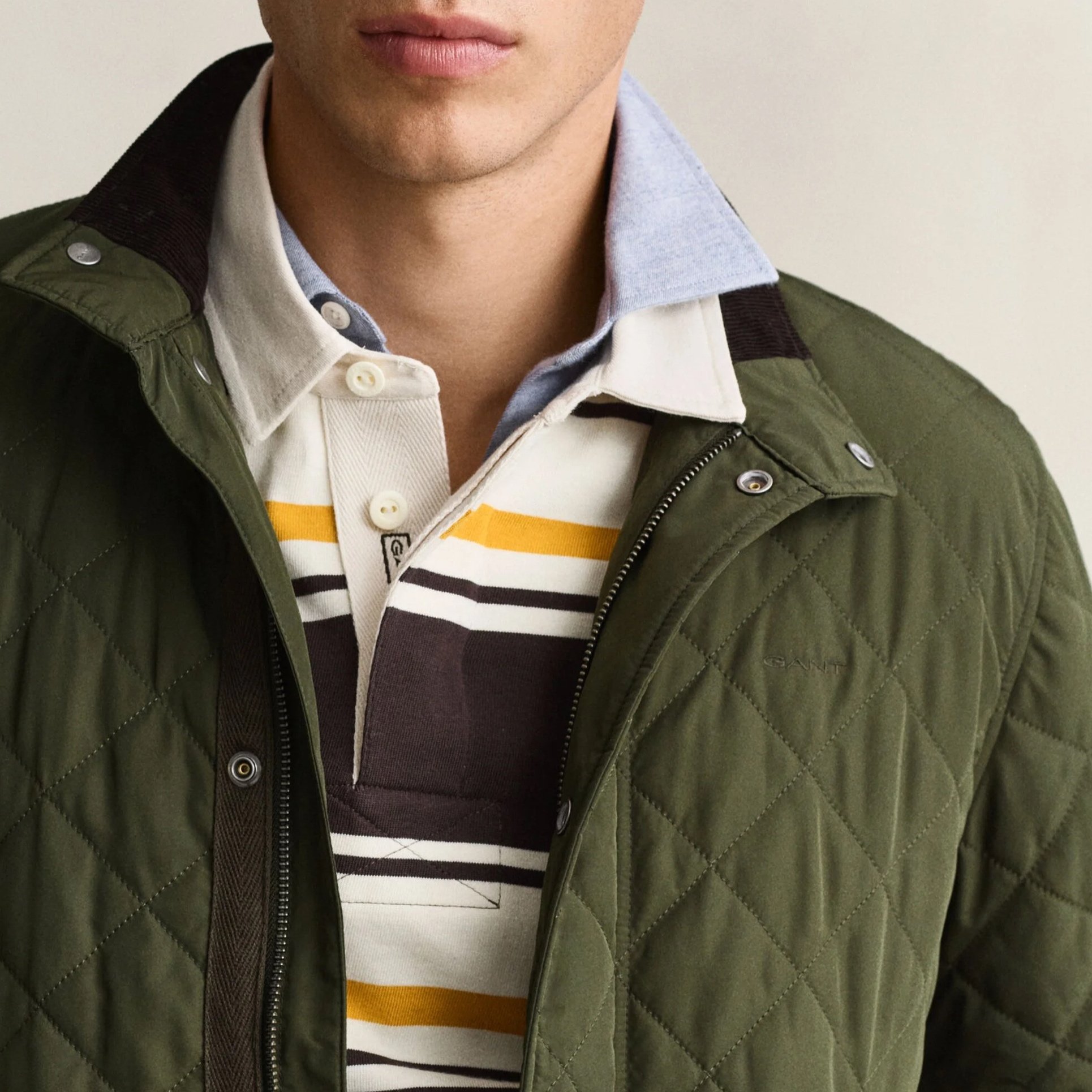 Close View of Model in GANT Quilted Jacket in Dark Moss Green