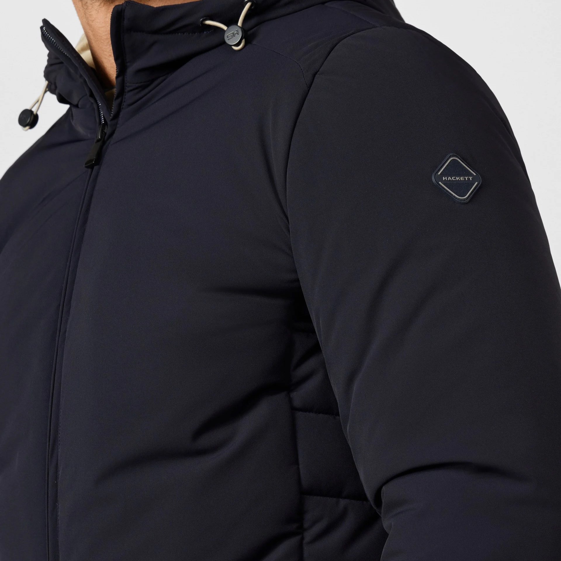 Close View of Model in Hackett Travel Puffer Jacket in Navy