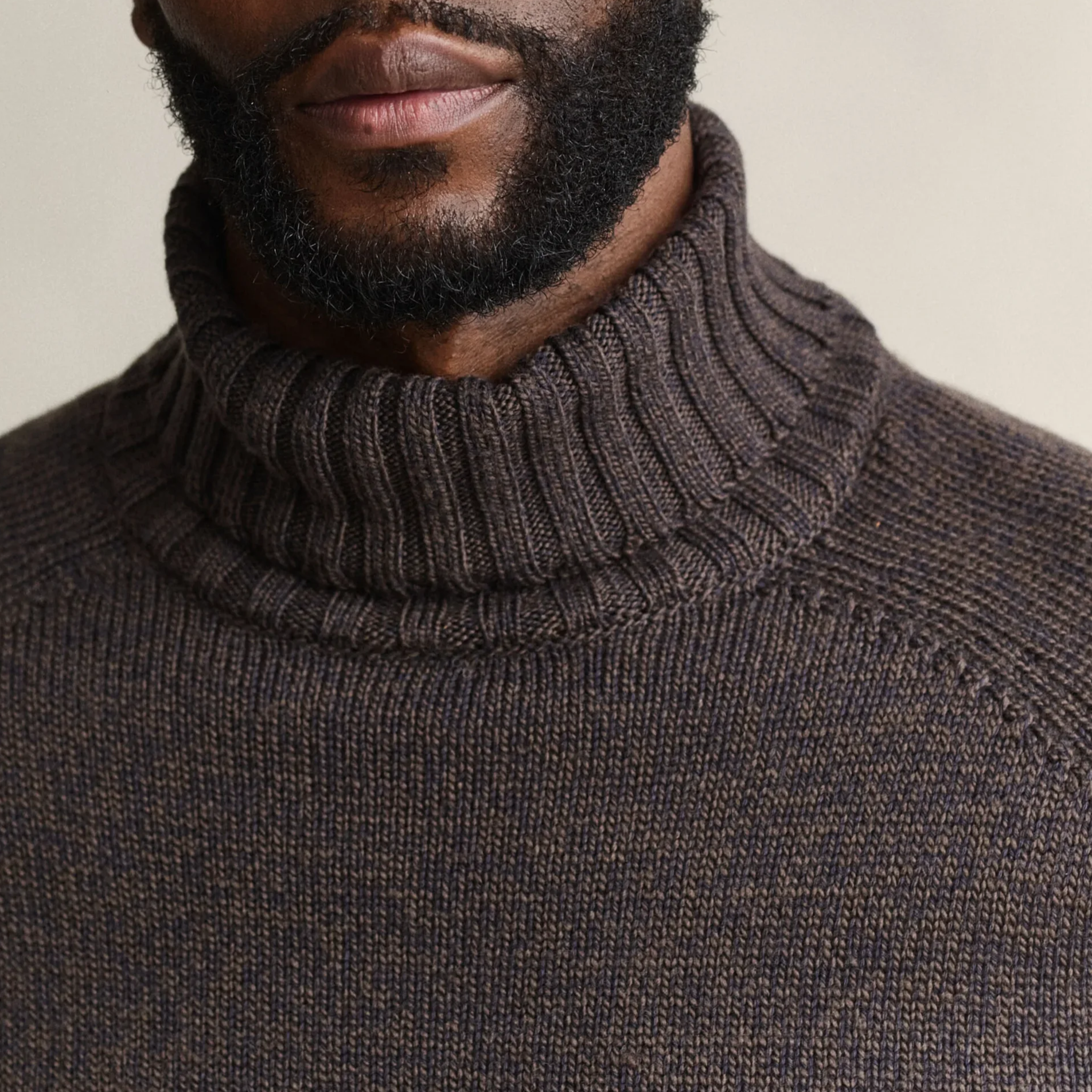 Close view of Model in GANT Wool Blend Mouline Roll Neck in Evening Blue and Brown