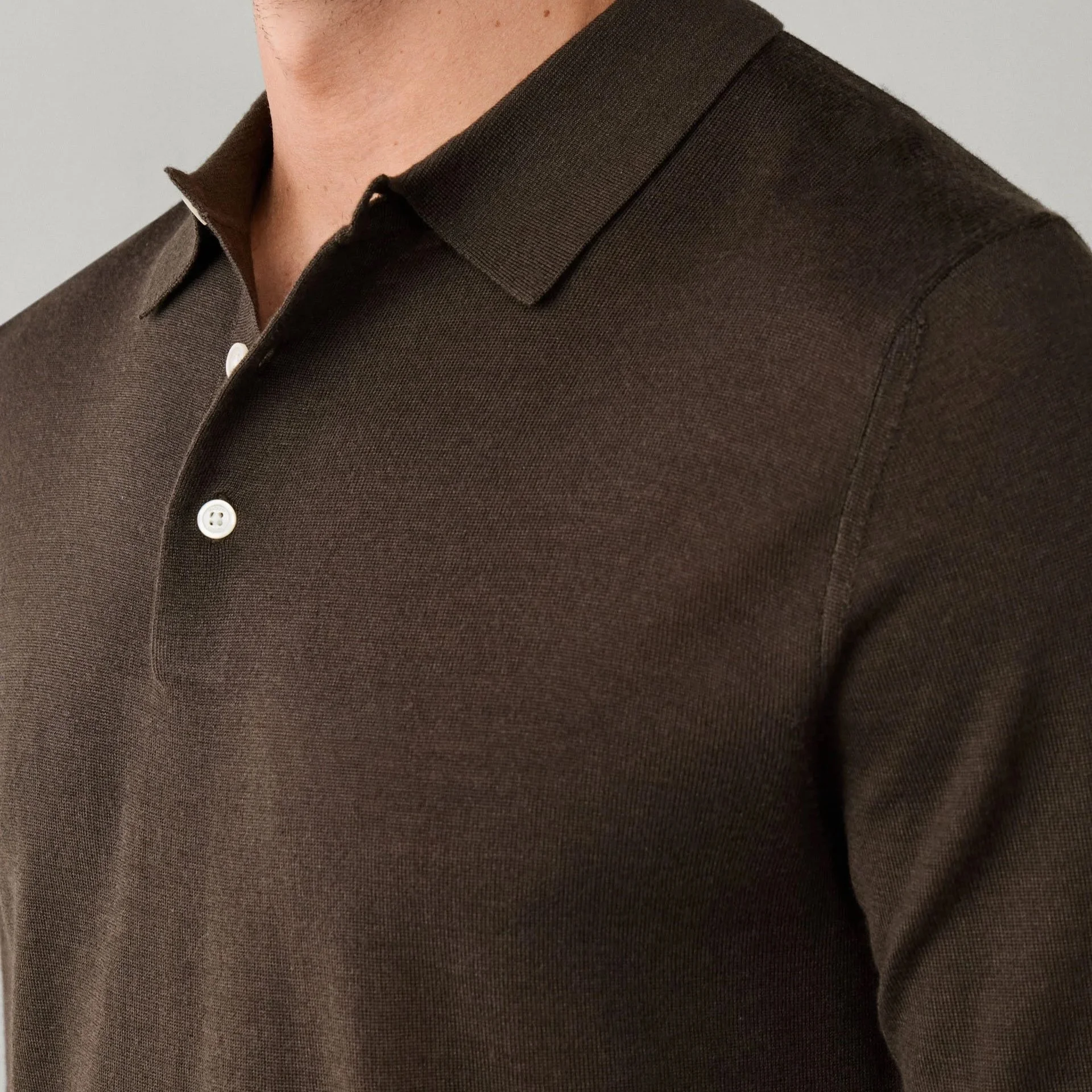 Close View of Model in Hackett Luxury Merino and Silk Long-Sleeve Polo in Vintage Green