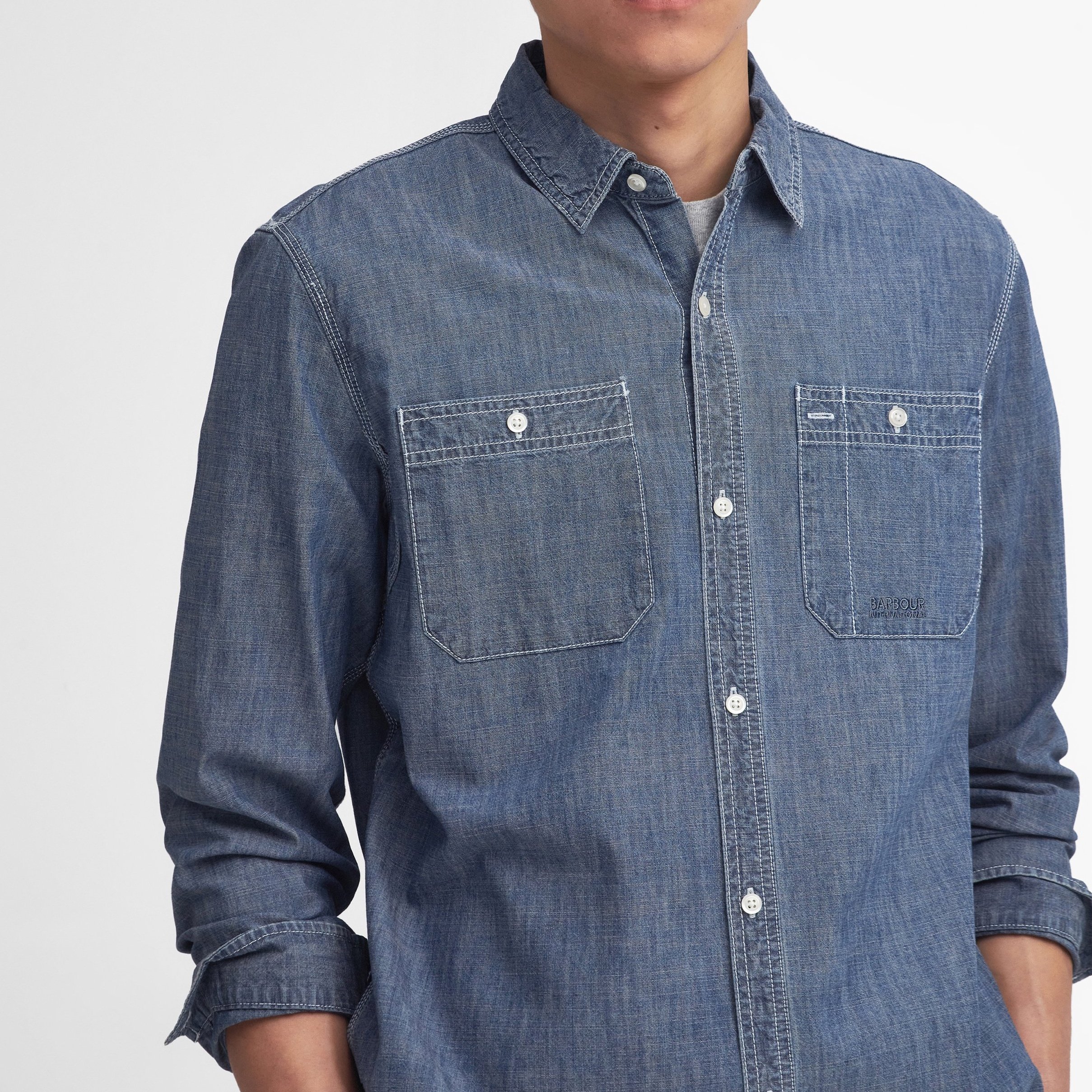 Close View of Model in Barbour International Denim Shirt in Washed Blue