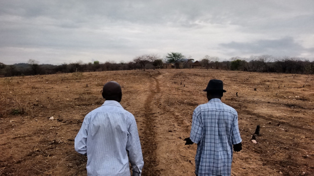 Ngoni Kadondo (left) and Isaac Kufandirori (right) walking towards Isaac's home in Nyamanyanya near Marymount Mission, Northeast Zimbabwe. Photo by Zack Moon.