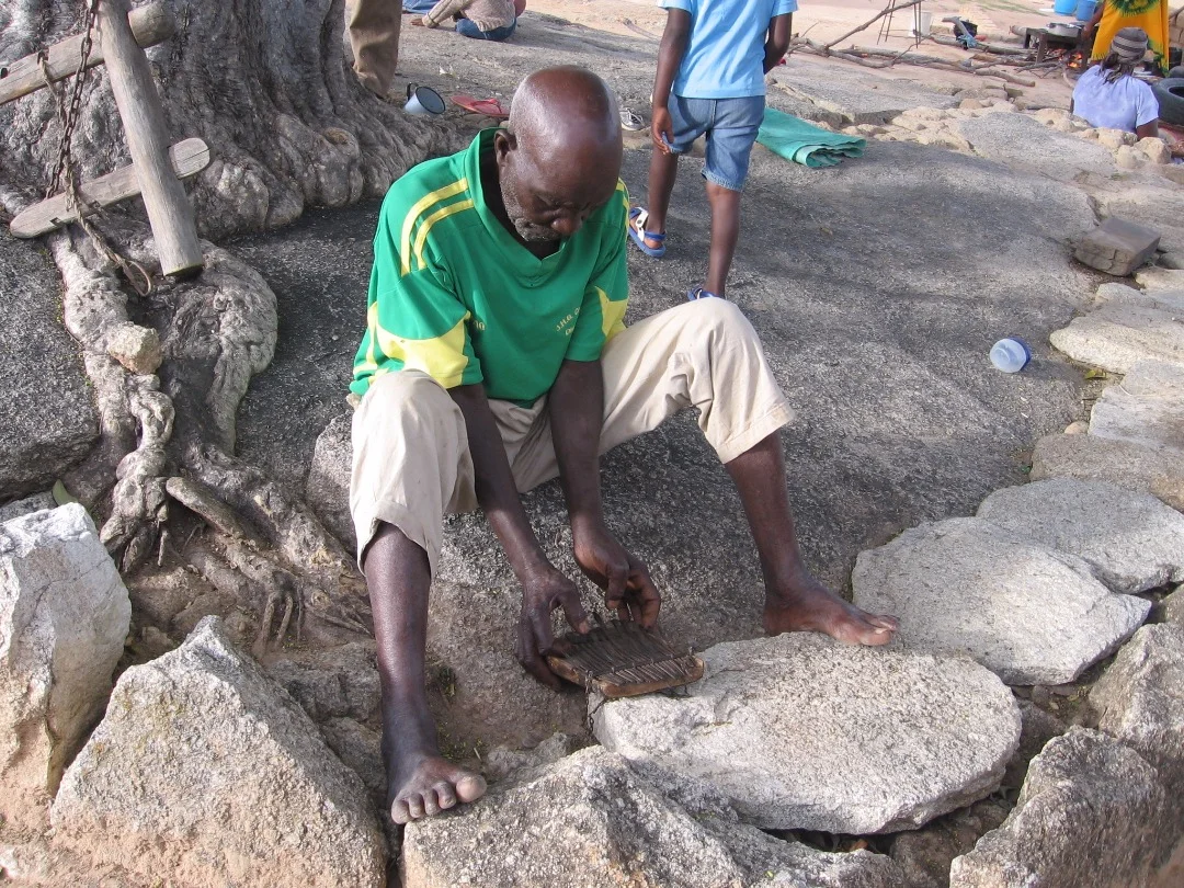 Partson Nyaruwabvu catches up on his playing with the repaired madhebhe.
