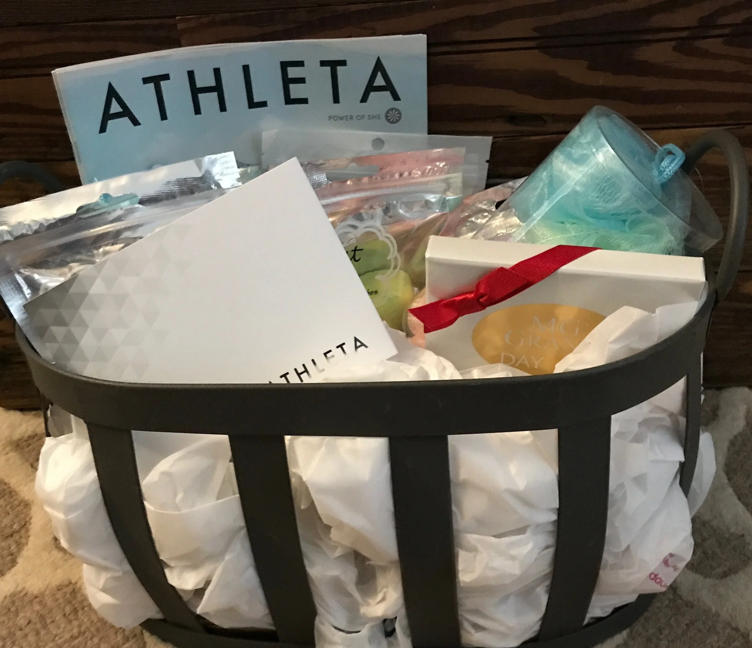 RELAXATION BASKET Spoil yourself with a little retail therapy followed by a spa day! Included are $50 Athleta gift card, $50 MG GRAND Day Spa Gift card, and a few loofahs and bath bombs. DONOR: 3rd Grade Classes VALUE: $105
