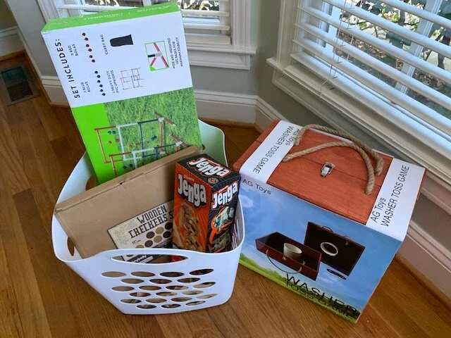 “FOOTBALL ‘GAMES”” BASKET Who doesn’t love a friendly game of Ladderball and Washers while you’re waiting for the game to start. If you don’t feel like moving from the television, enjoy some cards, table top Checkers, Tic Tac Toe, and Jenga. Fun for all ages. DONOR: 2nd Grade Classes VALUE: $92