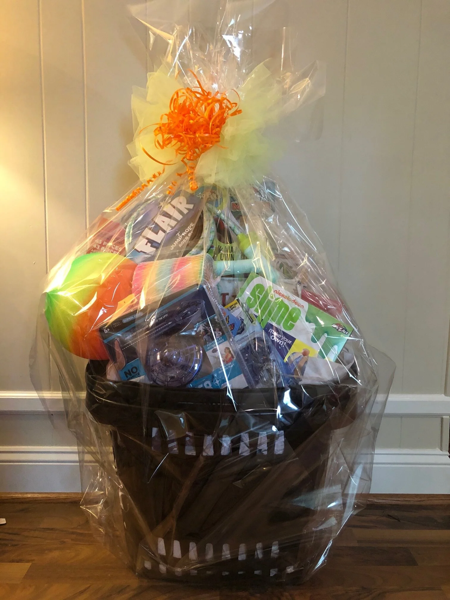 GENERAL TOY BASKET Toys for everyone! This multi-purpose rolling basket includes a large box of Magformers, Hover Star drone, Galactic Slime, Bop-it, giant Slinky, Beyblade, stickers, bouncy ball, jump rope, and Ticket to Ride game. DONOR: Kindergarten Classes VALUE: $134