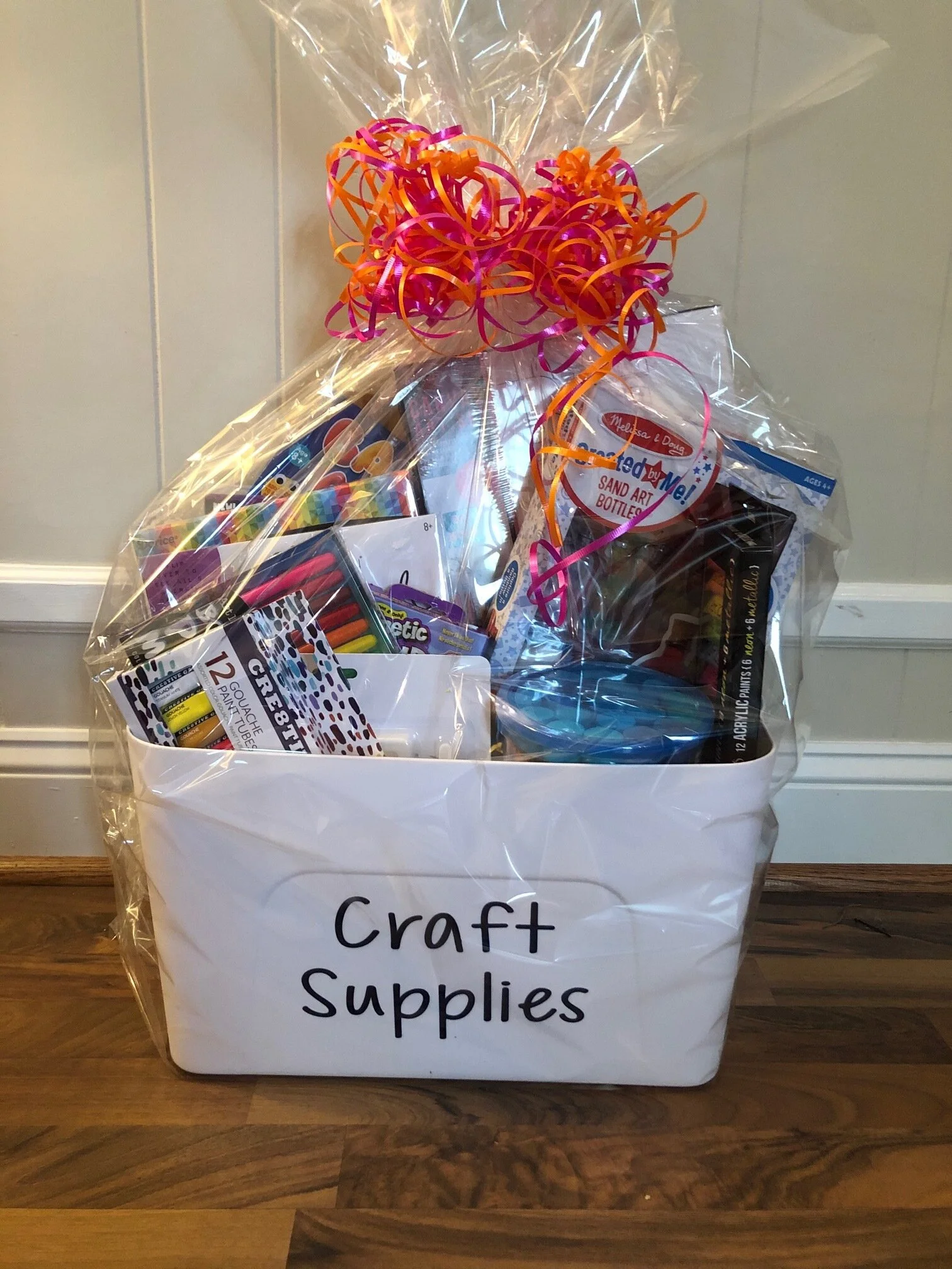 ART AND CRAFT BASKET Your resident artist and all their friends can do crafts for days! Canvases, markers, acrylic paints, decals and stencils, clay, chalk, kinetic sand, large set of slime, bounce putty, balloon animals, and sand art all packaged up in a customized container with a wooden lid that doubles as a coloring desk. DONOR: Kindergarten Classes VALUE: $86