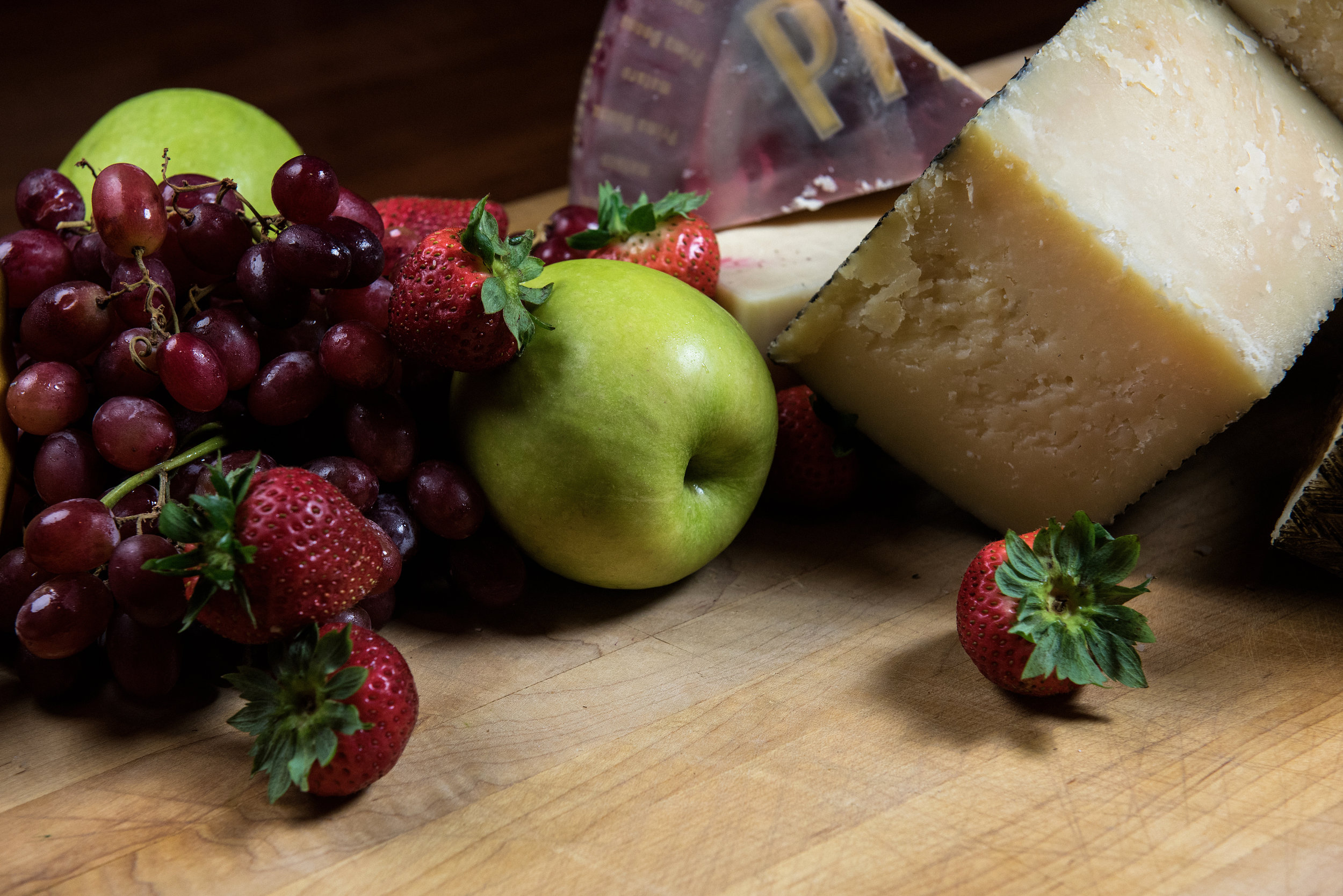 Fresh Strawberries, red Grapes, and an Apple with Cheese At Giumarello's