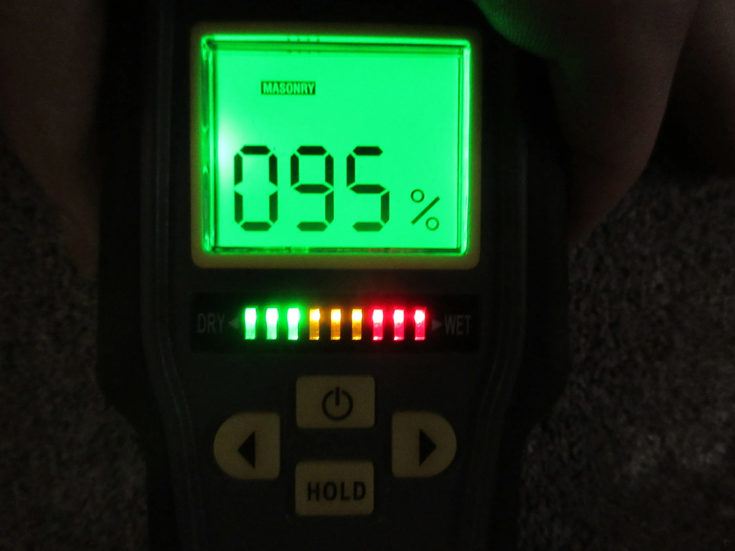 Signs of moisture penetration including efflorescence (salt escaping masonry) and high moisture readings at front left of crawlspace. Recommend adding diverter hoses to downspouts and correcting negative grading with landscaping.