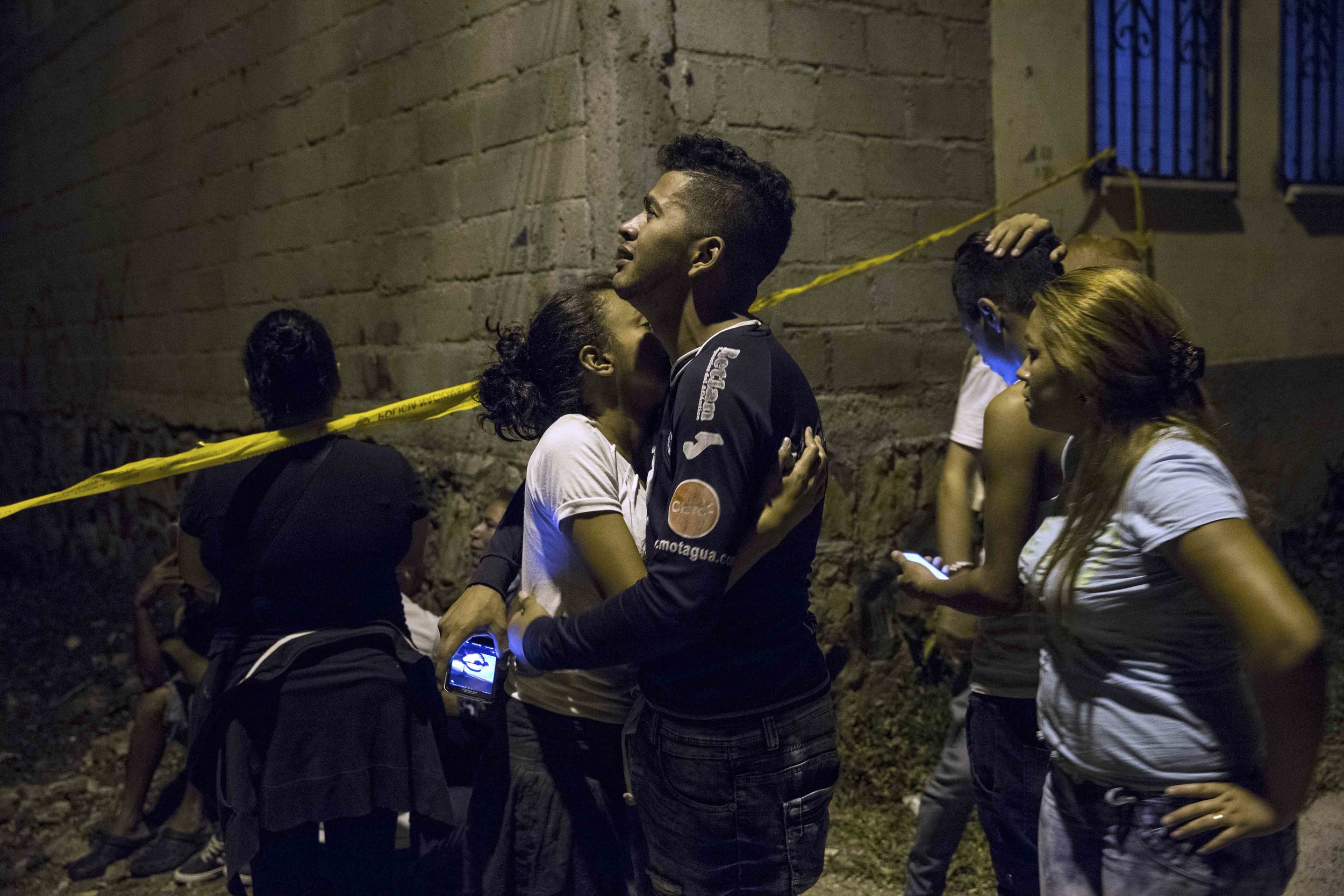 A boy mourns his brother, assassinated in a neighborhood, of Tegucigalpa, capital of Honduras. 