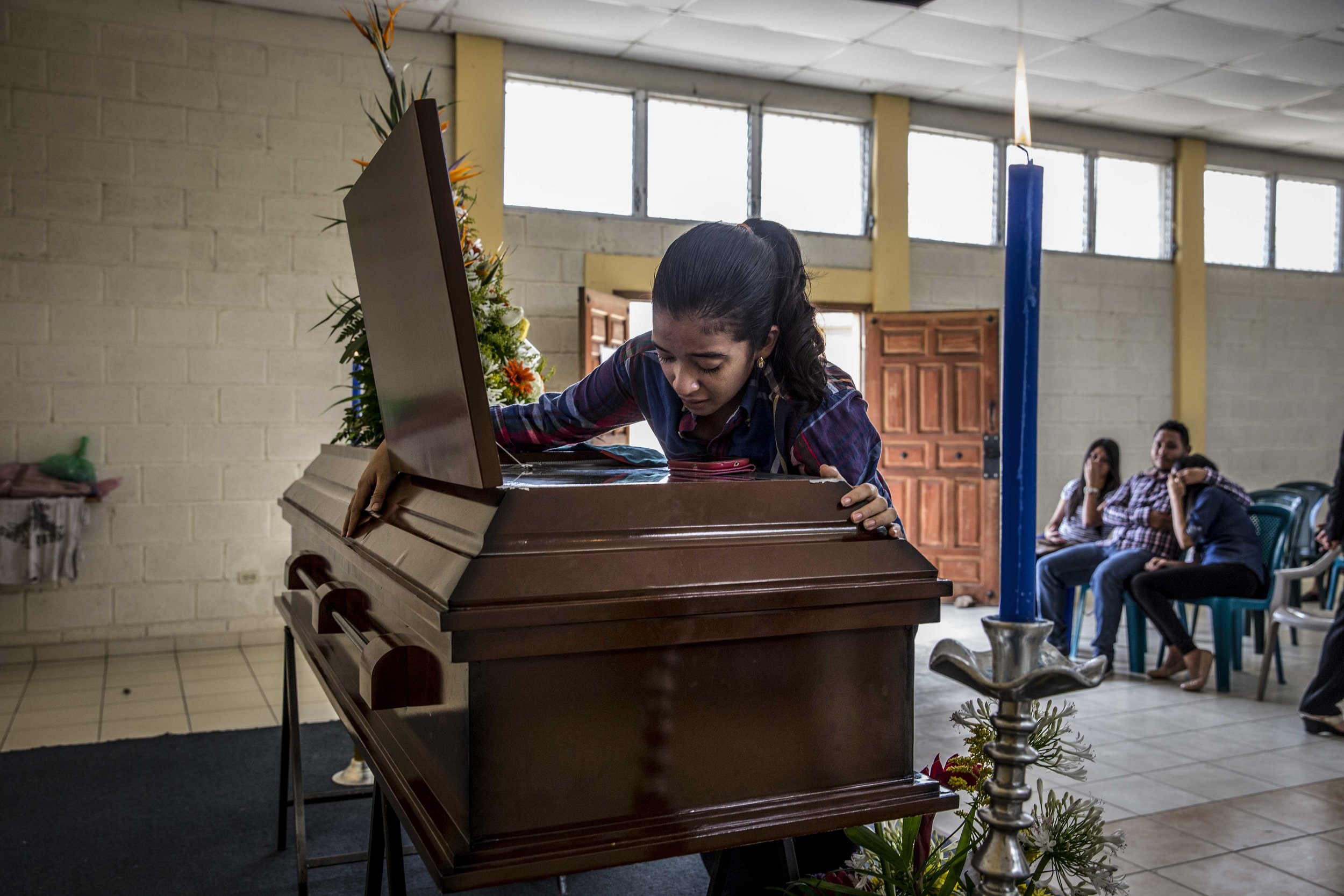 Relatives and friends of a boy murdered in the street a few days earlier, pay homage to him at his funeral held in a church building a few steps from the place of the murder, in one of the most dangerous neighborhoods of the capital Tegucigalpa, Hon