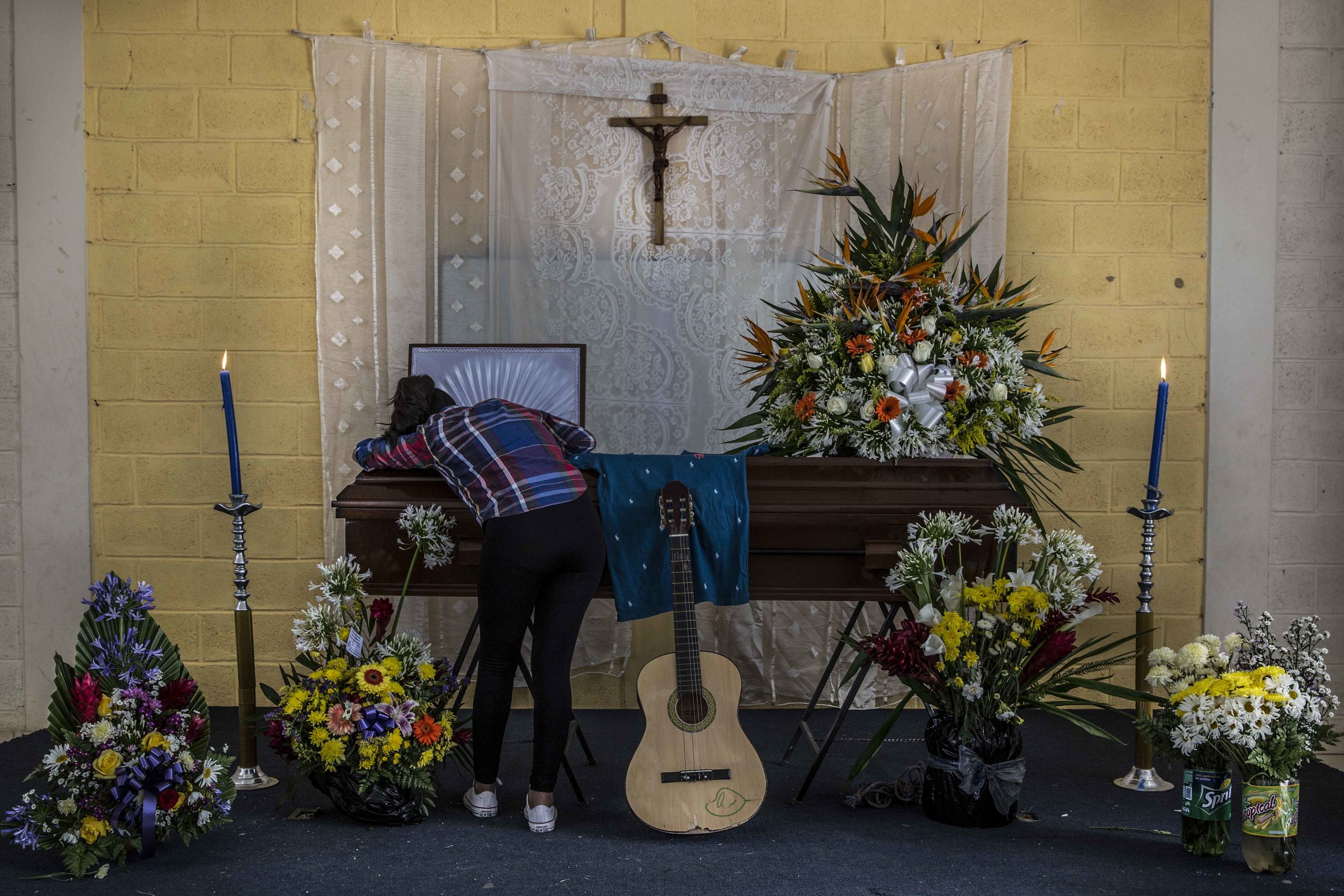  Relatives and friends of a boy murdered in the street a few days earlier, pay homage to him at his funeral held in a church building a few steps from the place of the murder, in one of the most dangerous neighborhoods of the capital Tegucigalpa, Hon