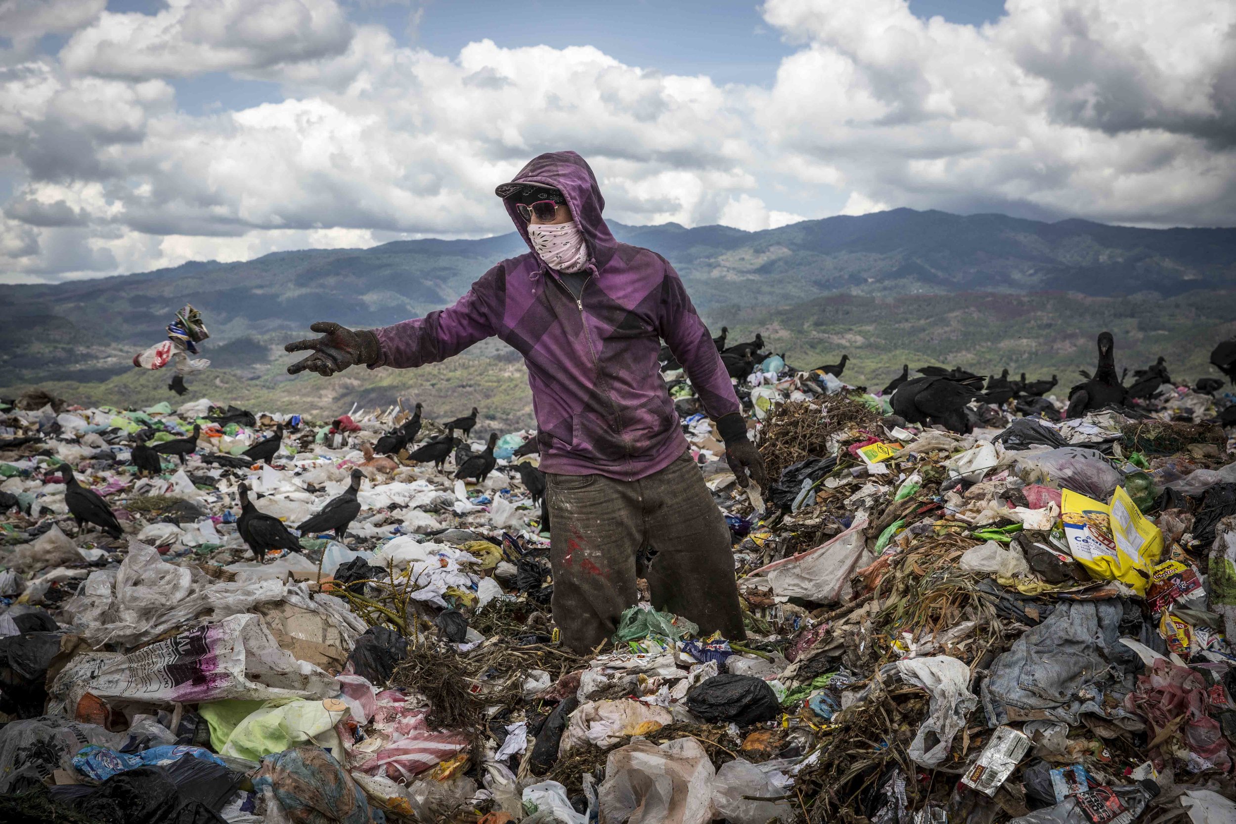 A boy searches for plastic material, in the main landfill in Tegucigalpa, which is under control of the local gangs. Everything is then sold for a few US dollars and in this way many make their living.