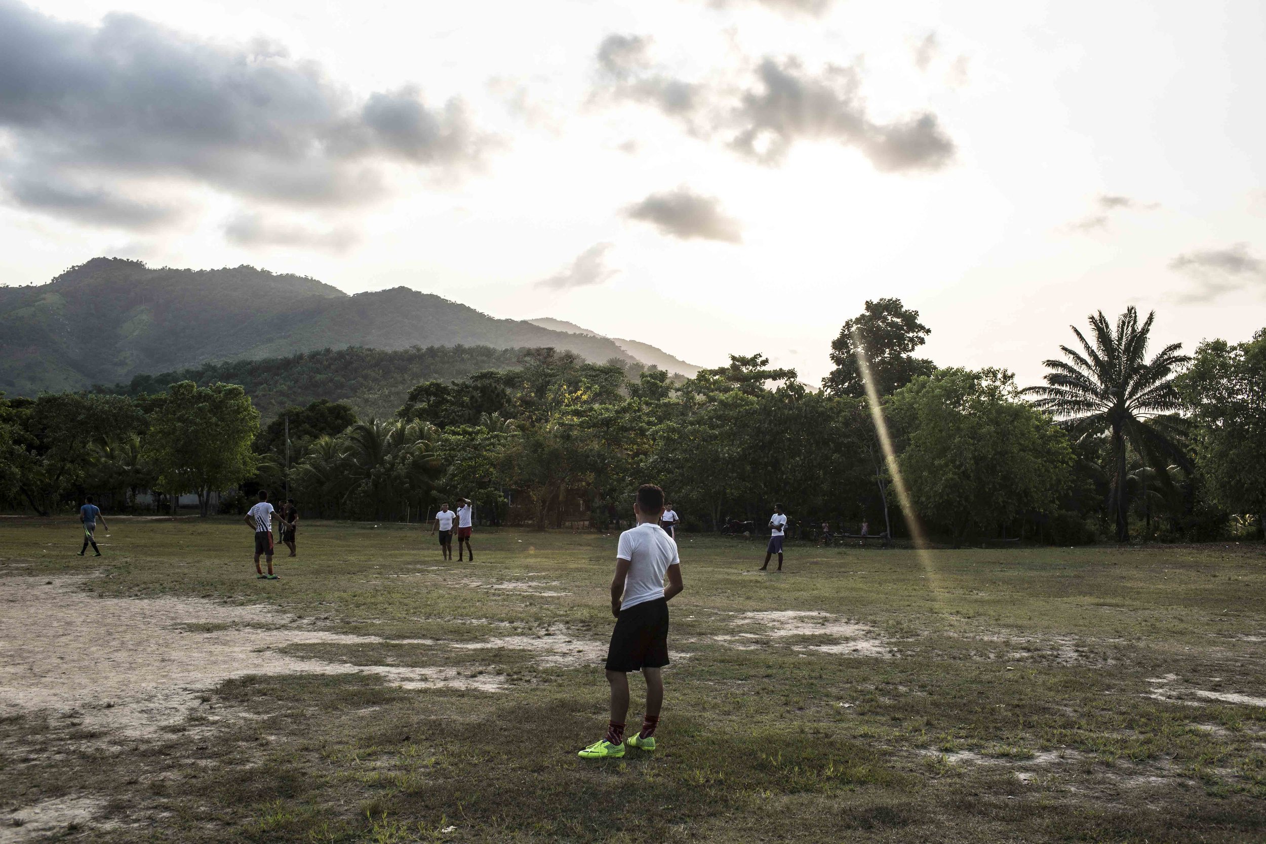 Young men in the football field of the Guadalupe Carney community, outside the city of Tocoa in the department of Colon, Aguan valley, on the Atlantic coast of Honduras. Insecurity in the Aguan valley has an active role in displacing people from the