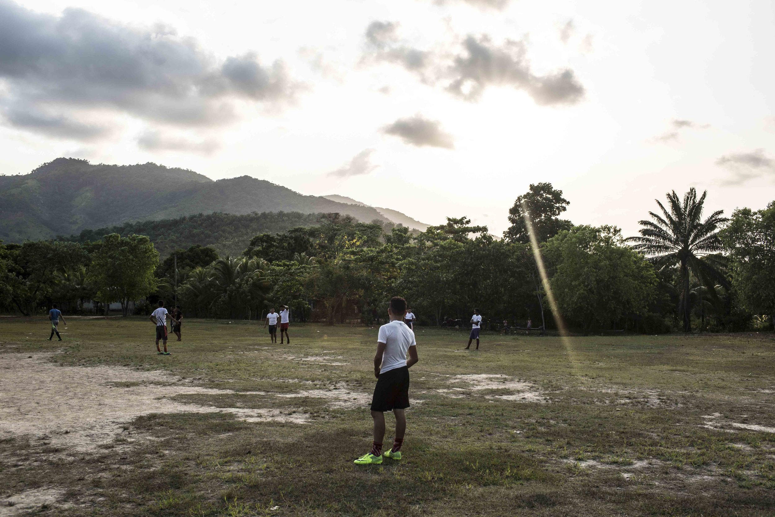  Young men in the football field of the Guadalupe Carney community, outside the city of Tocoa in the department of Colon, Aguan valley, on the Atlantic coast of Honduras. Insecurity in the Aguan valley has an active role in displacing people from the