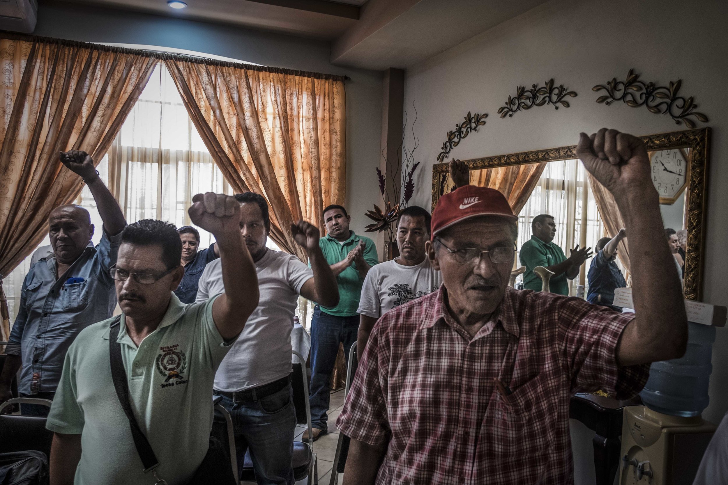 Representatives of the peasants organizations of men and women working in the African oil palm plantations in the Colon department, Aguan region, during assembly. It is not uncommon to see civilians bearing arms in Honduras, nor it is ille