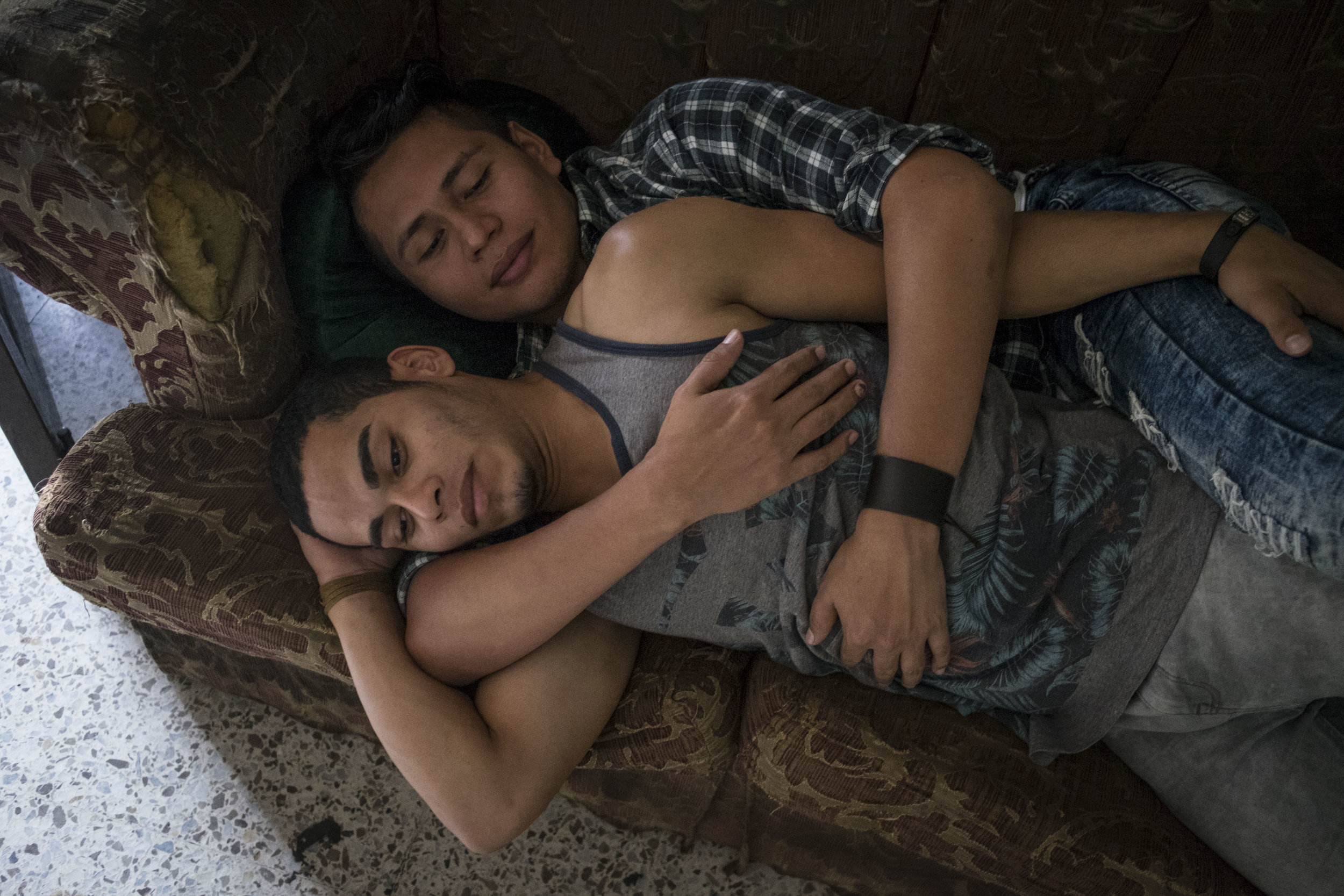  A couple embracing on the sofa in the premises of the LGBT organization Arcoiris, that is a space that aims to reunite homosexuals and transgenders in Tegucigalpa in a place where they can spend time feeling relatively safe. 