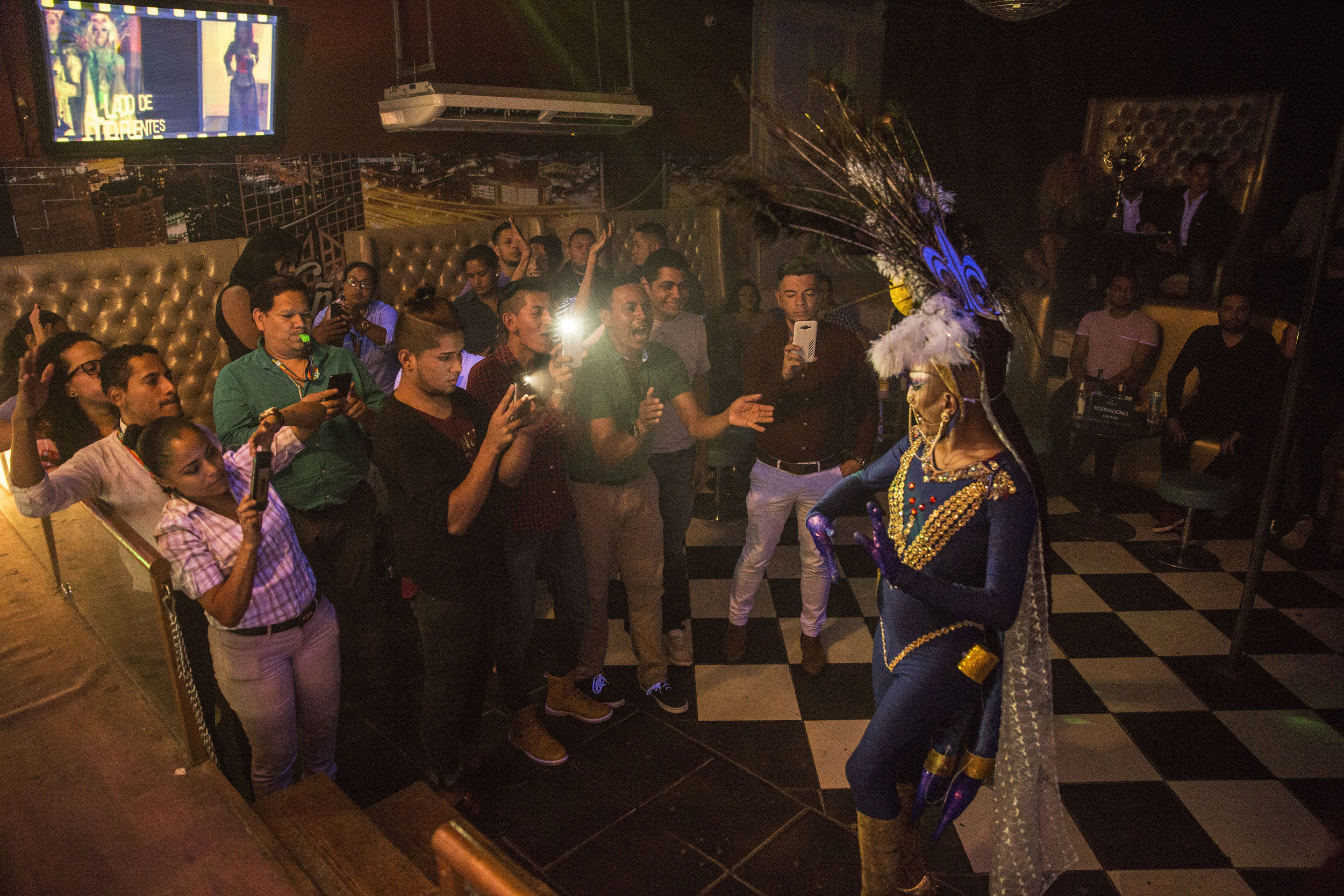  People show their support to their companion Diva Zuraika, during a beauty contest in gay club in Tegucigalpa, capital of Honduras. 