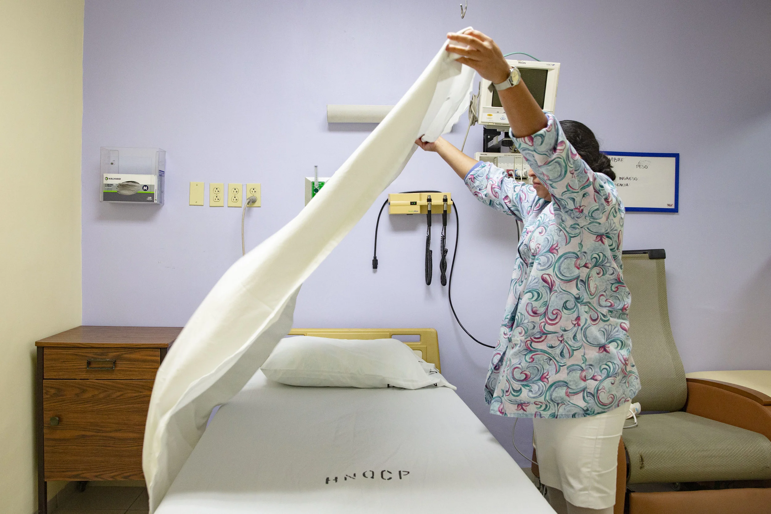 A nurse preprare a bed in the sections of the hospital that once was only reserved to burnt patiences but now is open to all those who need a reall sterile environment, at the Ruth Paz hospital in San Pedro Sula, Honduras.