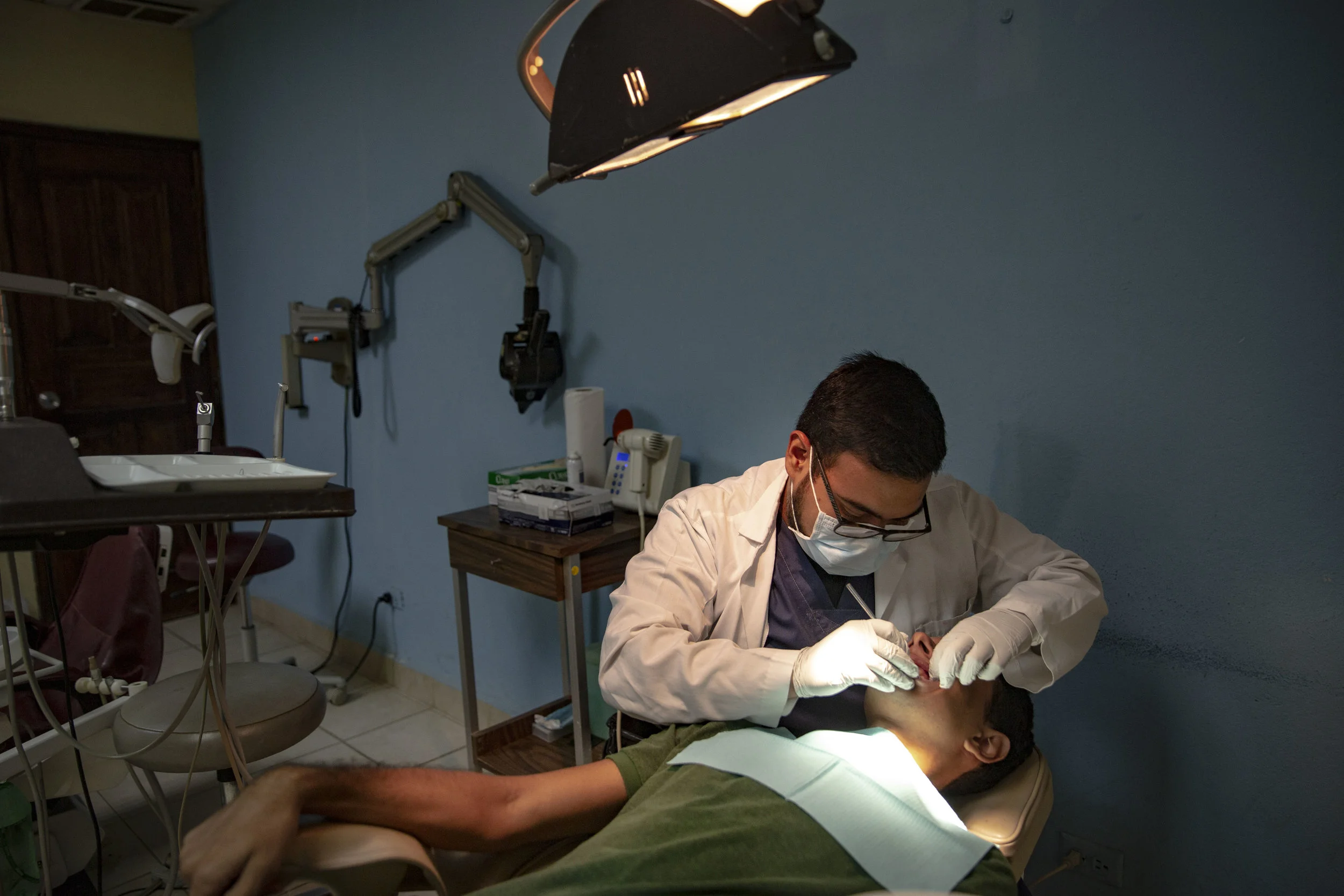 A dentist treat a patient at the Ruth Paz clinic in Bogràn, a pretty dangerous neighborohood in San Pedro Sula, Honduras.