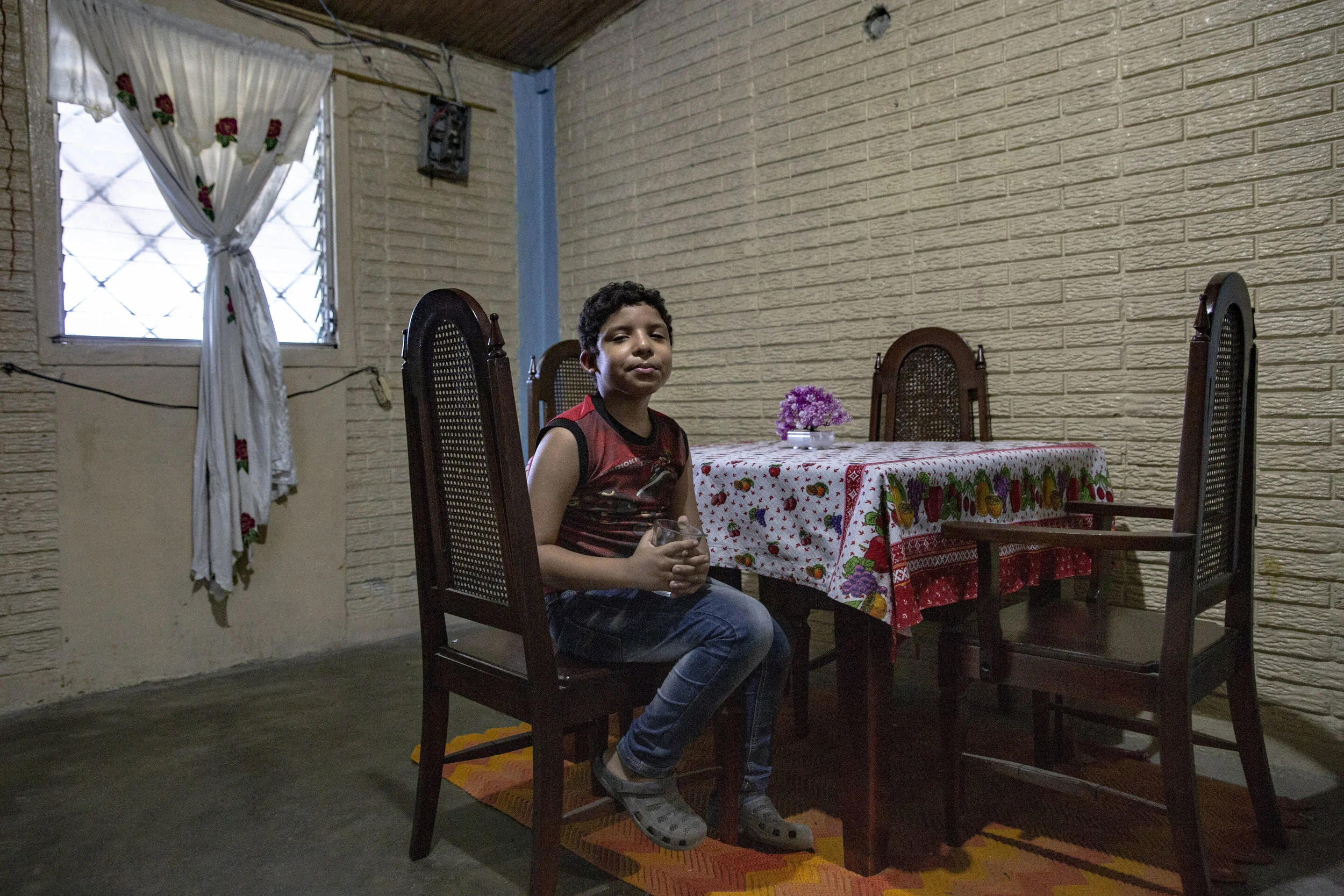 Jose Danilo Ramos is 10 and was born with anorectal malformation. Here in the living of his house where he lives with his family in San Pedro Sula, Honduras.