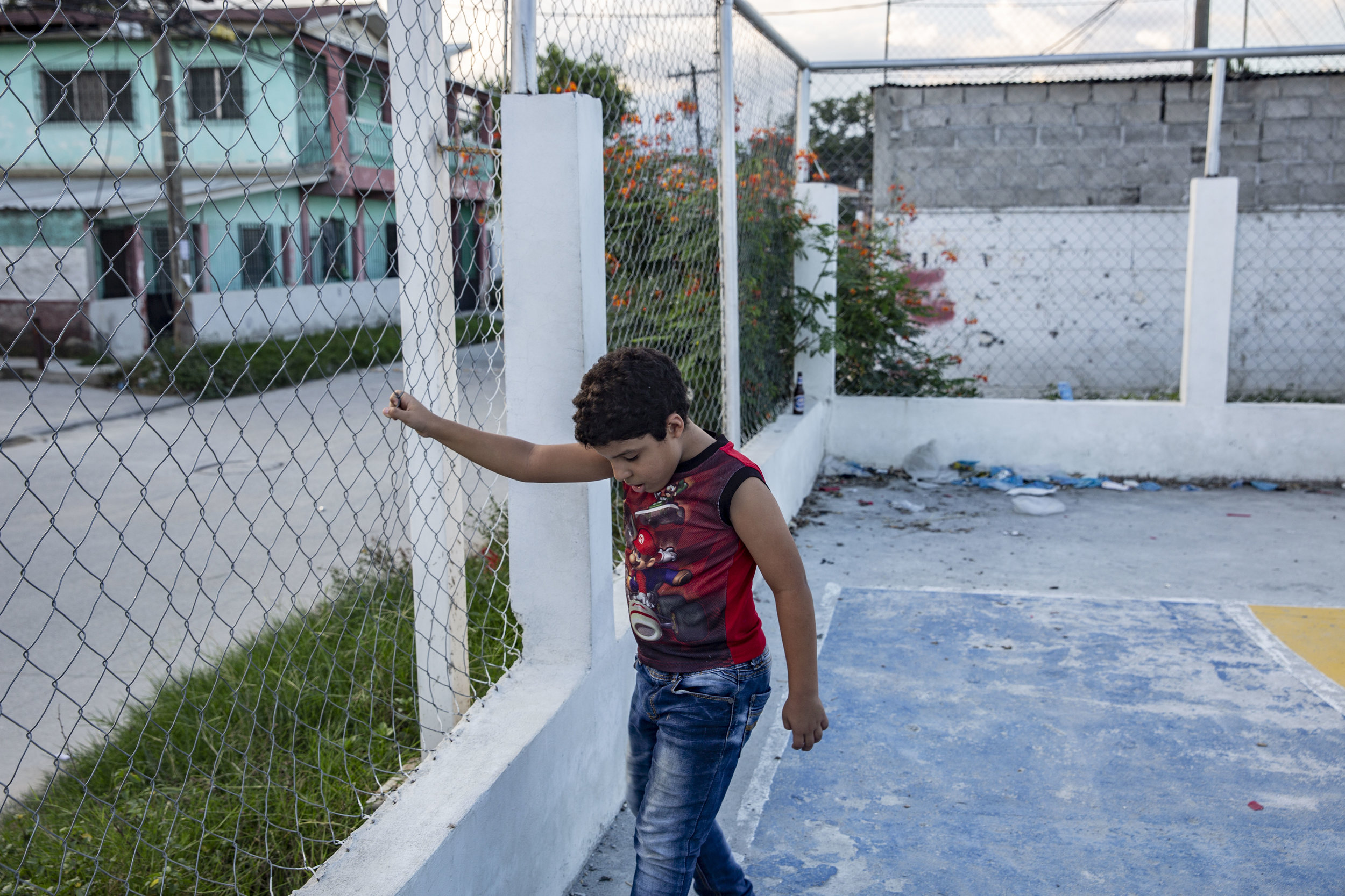 Jose Danilo Ramos laying football next to his house. He is 10 and was born with anorectal malformation. He had multiple operations at the Ruth Paz hospital, in San Pedro Sula, Honduras.