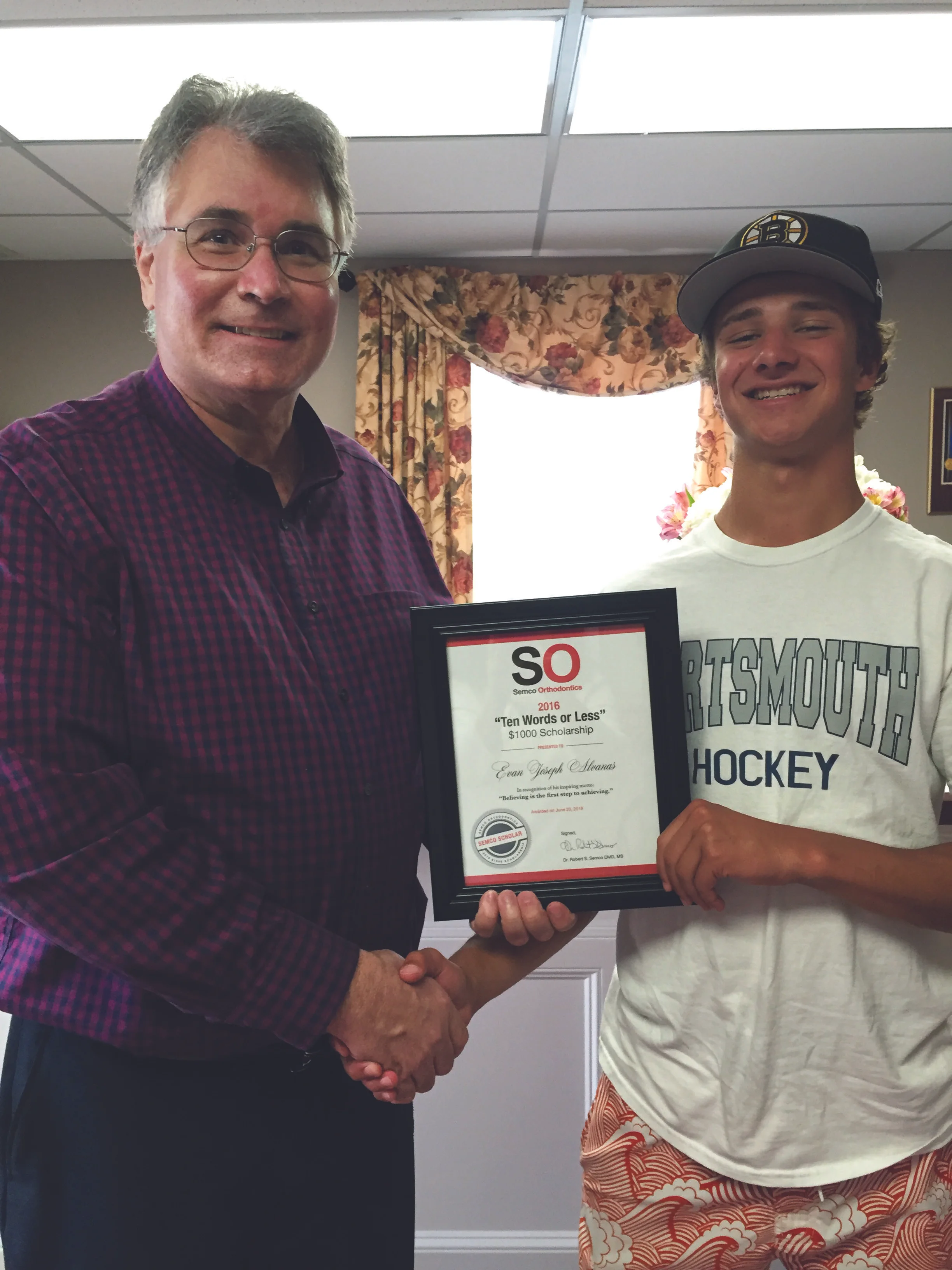 Evan receives his Scholarship certificate from Dr. Semco!