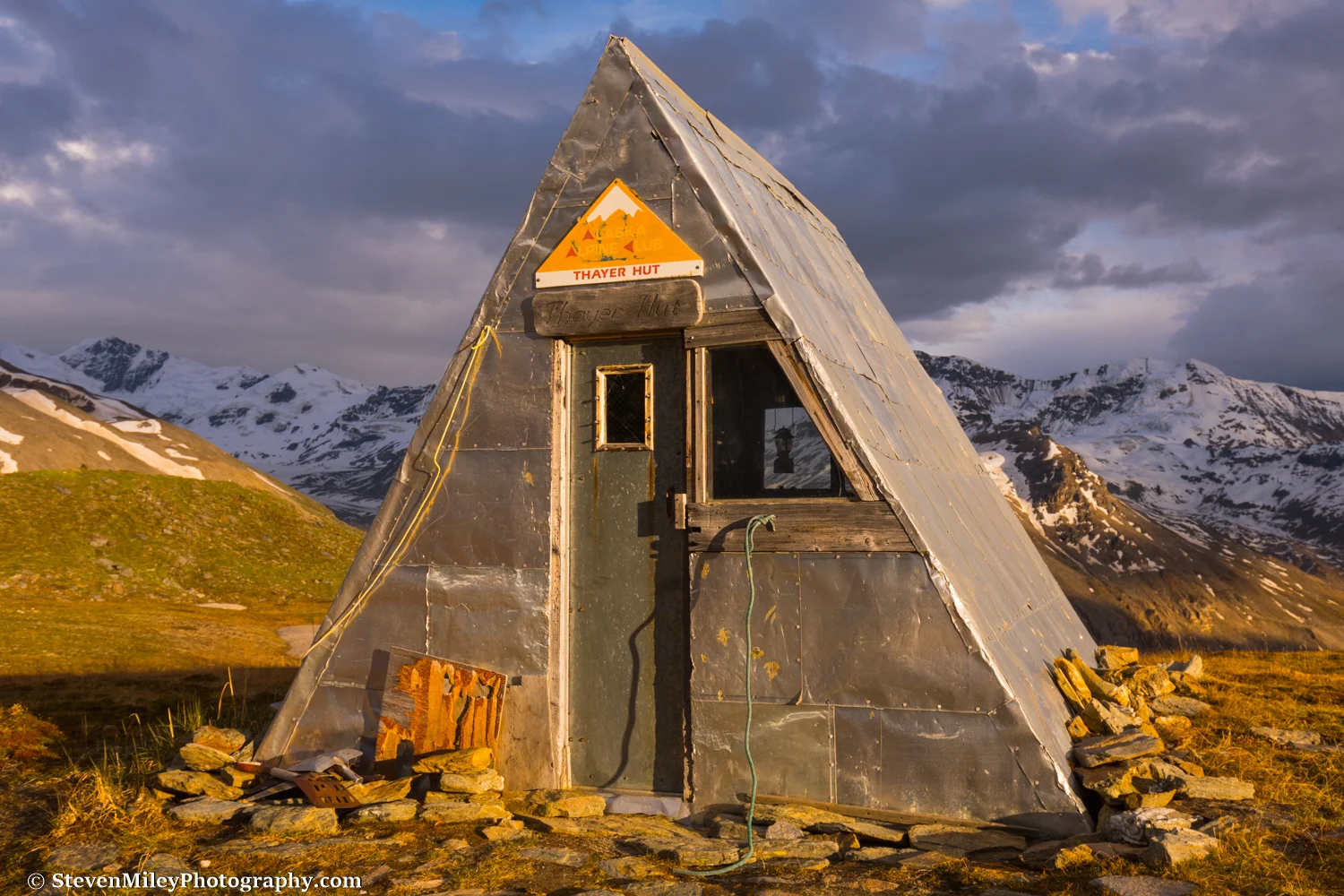 The Thayer Hut in the evening sun with the familiar lantern hanging in the window.