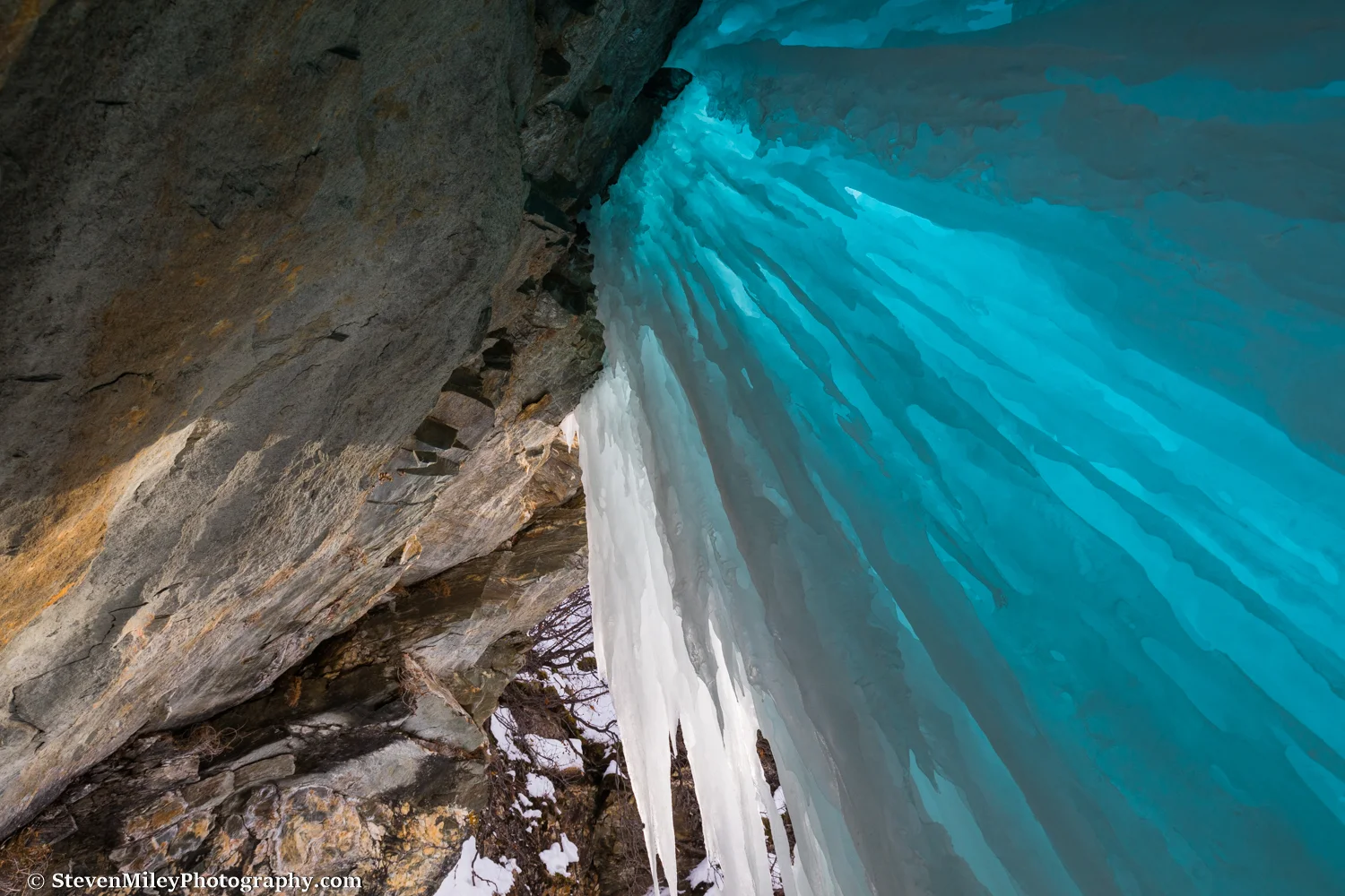 Looking up from an opening behind a frozen waterfall along Onemile Creek in the Alaska Range, near Black Rapids.