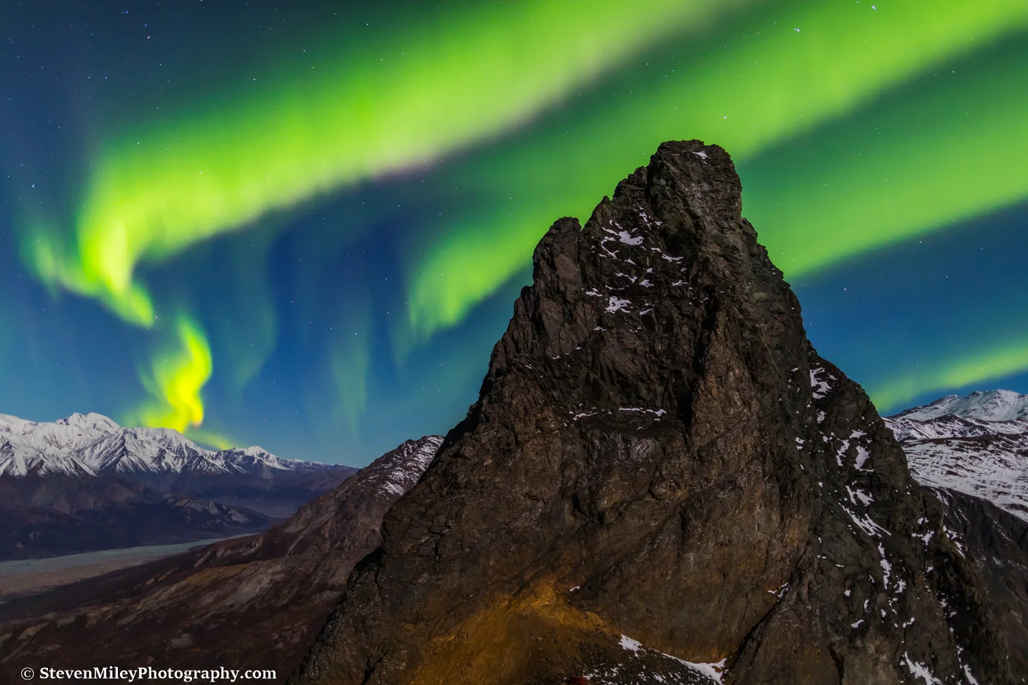 Aurora borealis over Devils Thumb in the Alaska Range, near Black Rapids.