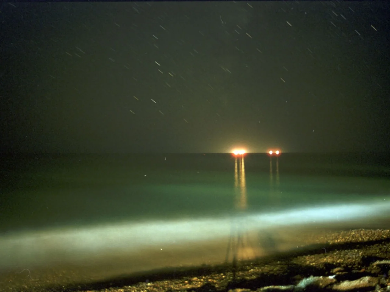 Red Shift Emily Richardson 2001 / 4 minutes / UK / 16mm / sound In astronomical terminology redshift is a term used in calculating the distance of stars from the earth, hence determining their age. Redshift attempts to show the huge geometry of the night sky and give an altered perspective of the landscape, using long exposures, fixed camera positions, long shots and time-lapse animation techniques to reveal aspects of the night that are invisible to the naked eye. The film has a gentle intensity to it, and is composed of changes of light across the sea, sky and mountains. It shows movement where there is apparent stillness, whether in the formation of weather patterns, movement of stars, the illumination of a building by passing car headlights or boats darting back and forth across the sea’s horizon. The sound has been composed for the film by Benedict Drew, taking field recordings of the aurora borealis as a starting point, and using purely computer generated sound to create a soundtrack that reflects the unheard elements present in the earth’s atmosphere. -ER