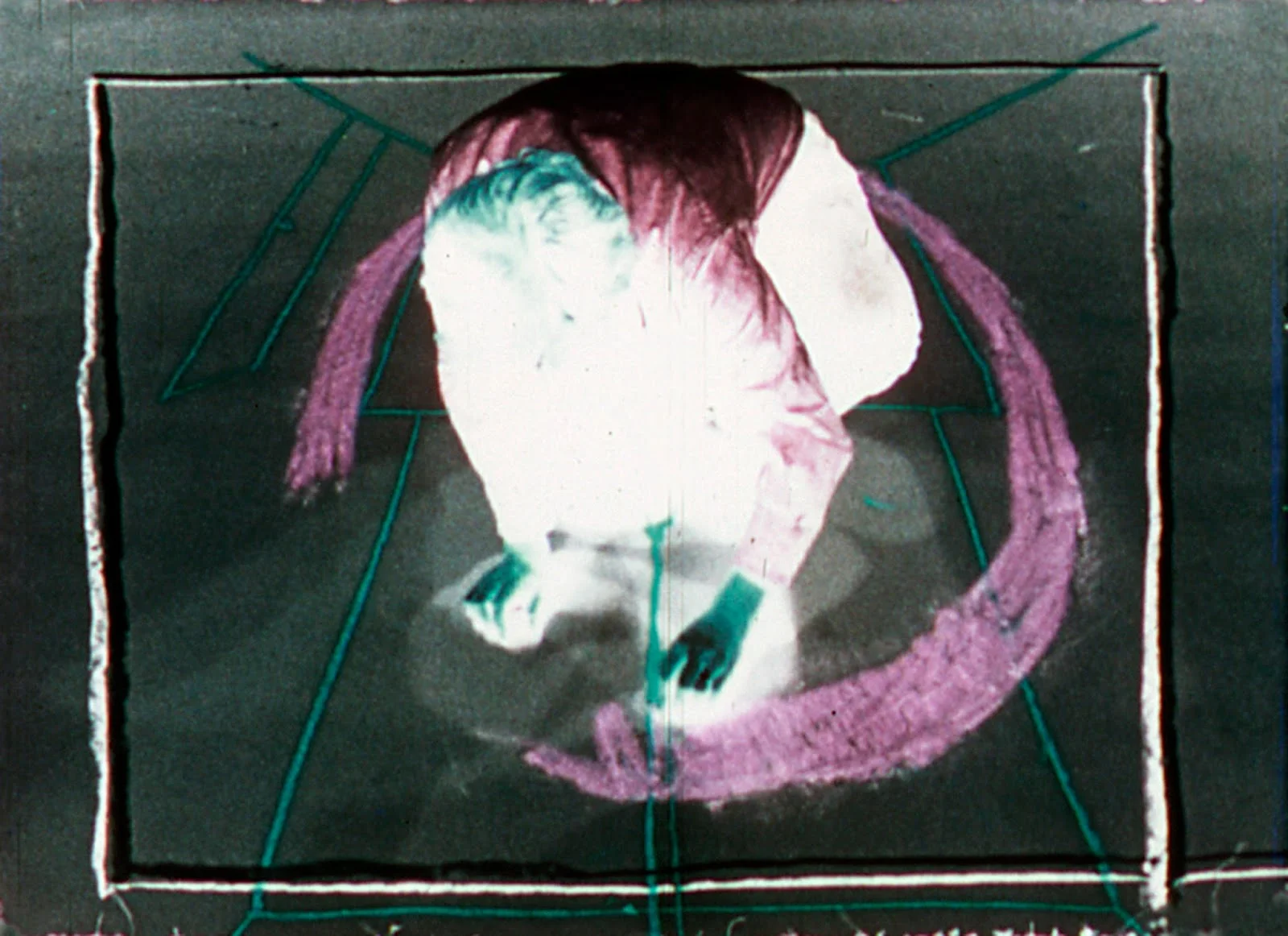 Cube and Room Drawings David Haxton 1977 | 15 minutes | USA | 16mm | color | silent Restored print courtesy of the Academy Film Archive Cube and Room Drawings begins with a view looking down at an angle toward grey paper covering the floor. A performer enters from the back of the scene and begins drawing lines on the floor. The lines are the beginning of a drawing of a distorted cube. The performer leaves the scene. The paper begins to rotate on the floor. As the paper rotates the cube gradually becomes correctly oriented, as if it were drawn on a vertical piece of paper. The performer enters again and draws another cube that corresponds to the perspective of the other cube. After leaving and re-entering the performer draws red receding lines on the floor. He leaves and the paper rotates and the red lines become a grid that corresponds to the vertical screen. The film continues with several additional actions that continue this theme.