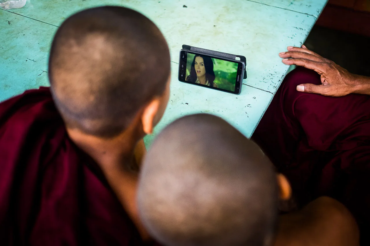  The head monk plays a pop music video on his device in a remote Nyanungbin monastery. Mobile phones have only been made available to Burmese citizens in the past few years. &nbsp;Previously, a SIM card cost a whopping 2000 USD.  Burma 2015 - Francesco Vicenzi Photography 