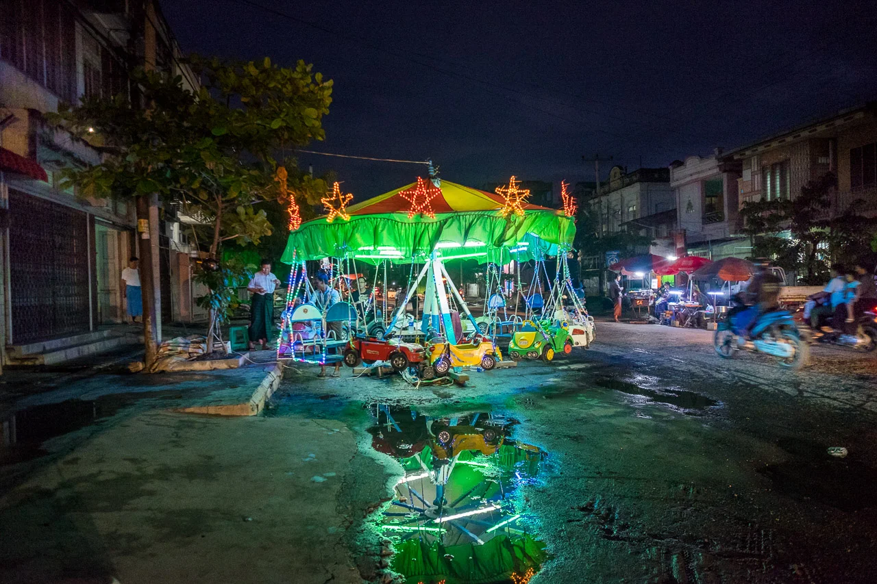  A man-powered merry go round in Mandalay: the operator spins the carousel by hand.&nbsp;  Burma 2015 - Francesco Vicenzi Photography 