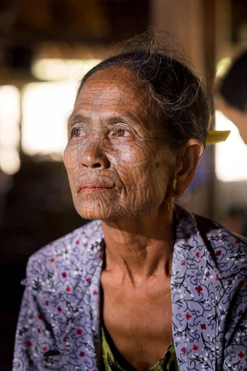  Portrait taken in remote Chin village in Burma. Banned in the 1960s by the Burmese Government, the practice of tattooing girls' faces aimed to disguise their beauty and protect them from abductions by the king. Another theory states that the tattoos simply mark the belonging to a specific tribe.  Burma 2015 - Francesco Vicenzi Photography 