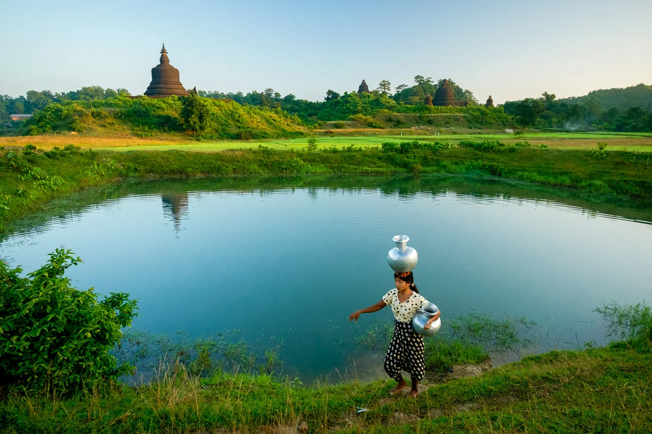  A woman collects water for the house in Mraek-U, Rakhine state in Myanmar. Water must be collected twice a day at both dawn and dusk, to be used for drinking, cooking and tea.  Burma 2015 - Francesco Vicenzi Photography 