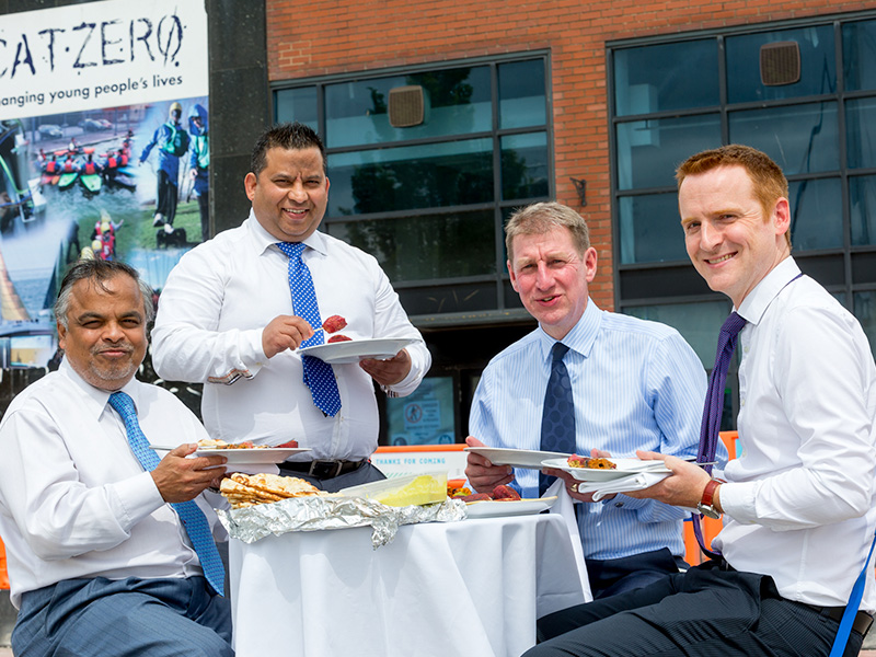 Tapan Mahapatra, left, and Mukesh Tirkoti enjoy an impromptu Tapasya meal with Wykeland Group’s Property Director David Donkin and Development Surveyor Tom Watson, right, outside the former CatZero building which is being converted into Tapasya @ Marina.