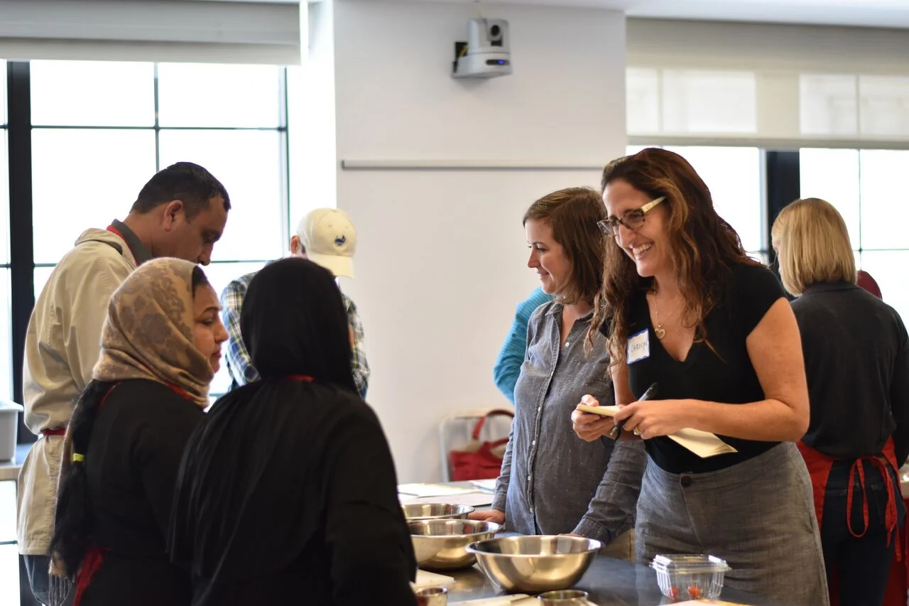 Carolyn Cannuscio works with students in the Edible Alphabet program, an ESL and cooking class for refugees. The class is run through the Free Library of Philadelphia's Culinary Literacy Center .