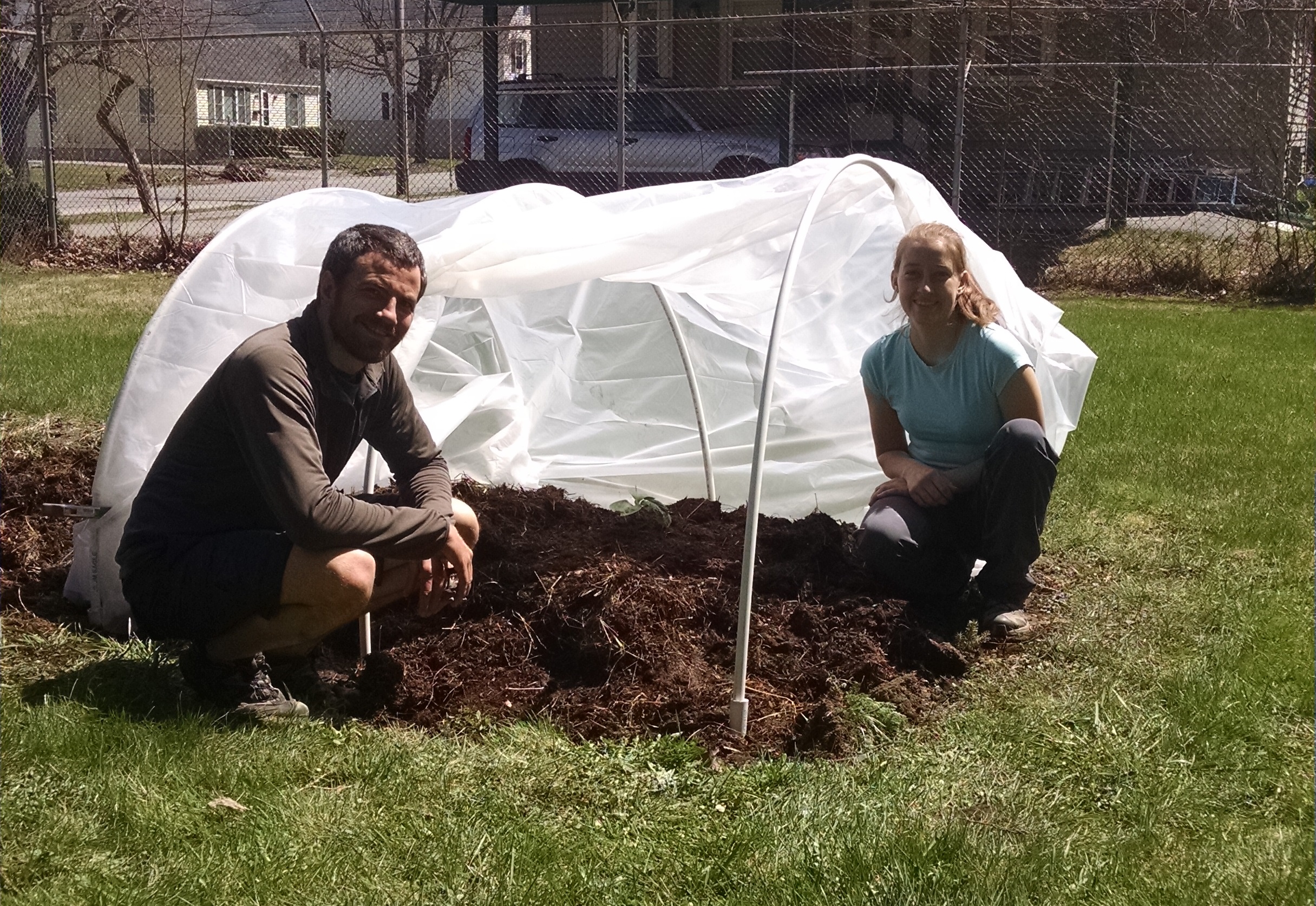 Posing with our seedling and hoop house at the Bangor Community Garden.