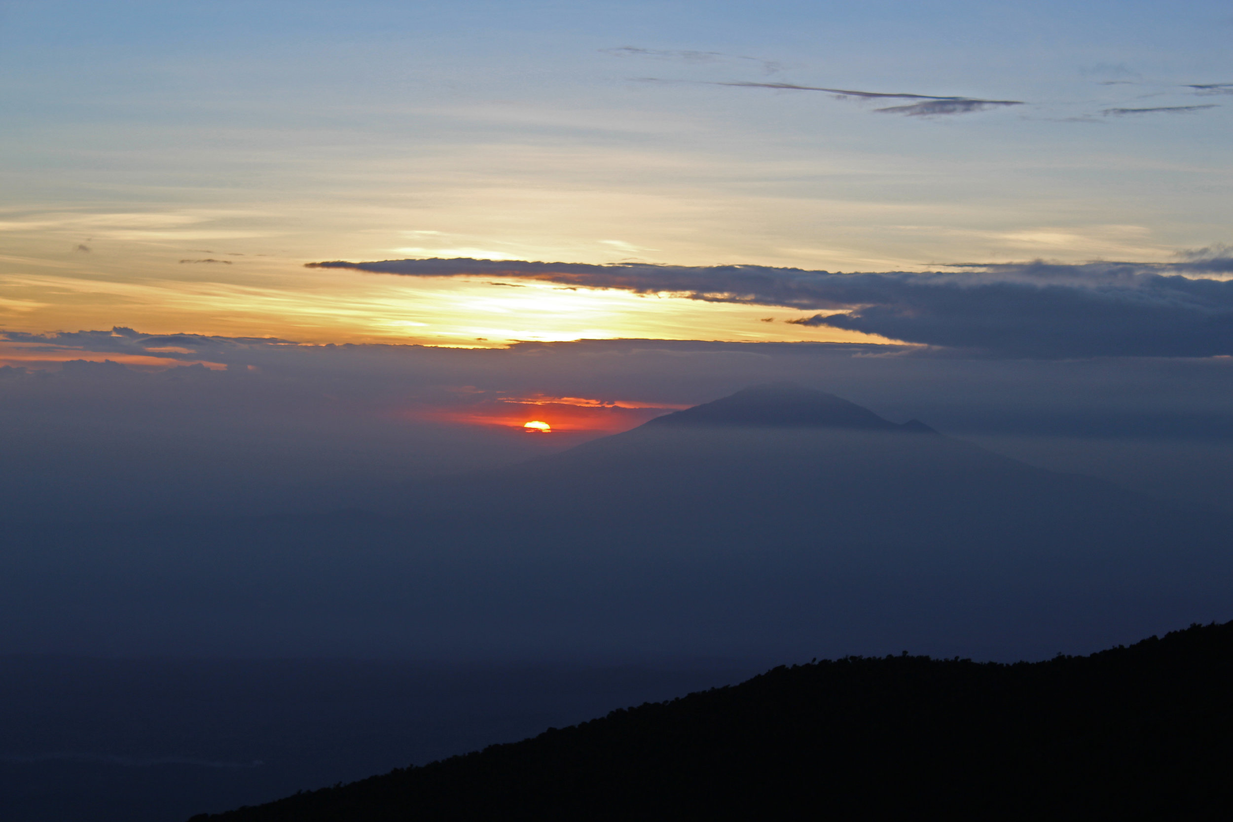 Watching the sun set behind Mount Meru from Karanga Valley Camp on Mount Kilimanjaro