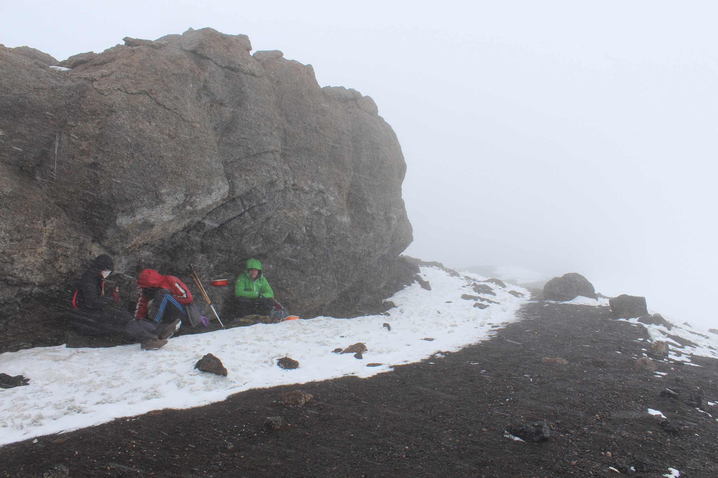 Taking shelter from the snow and wind at Stella Point.