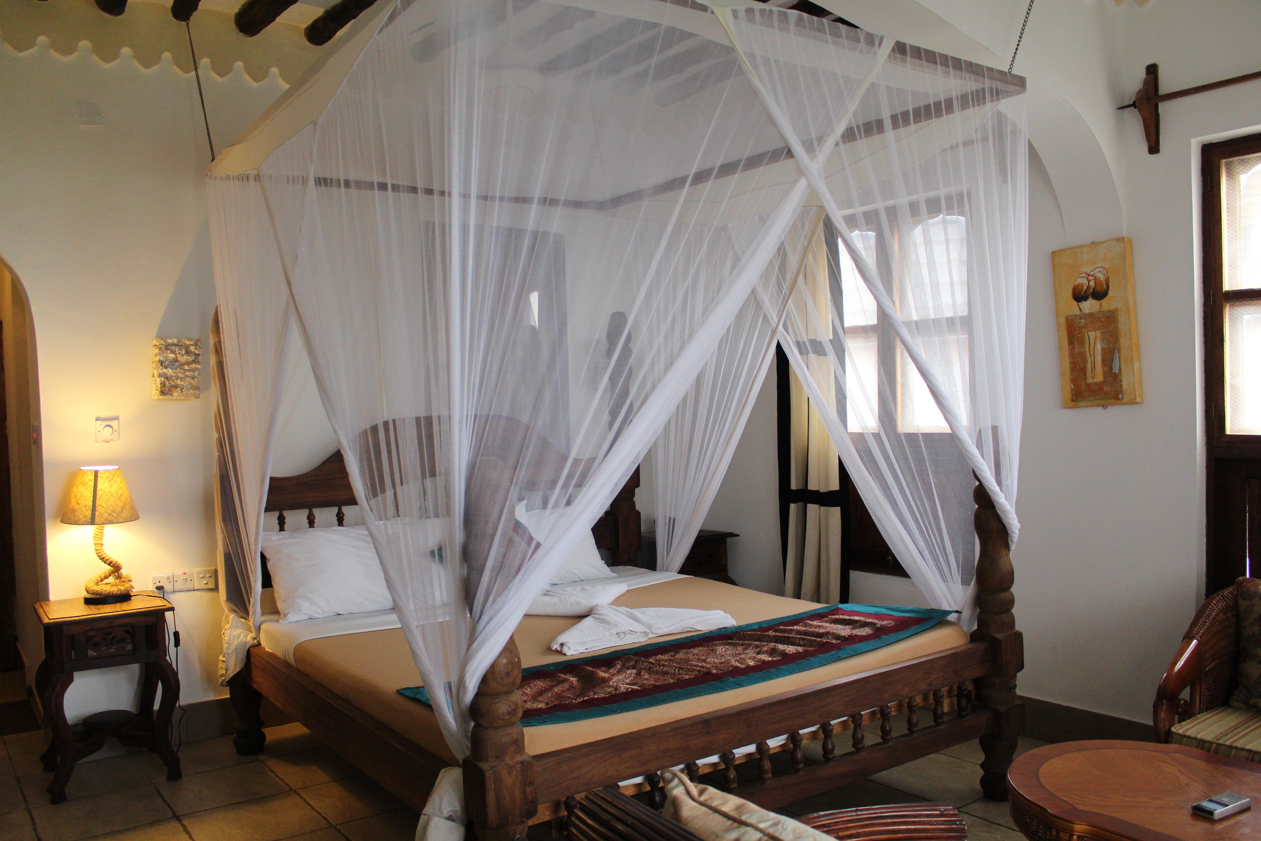 Our beautiful room and bed with mosquito netting at Langi Langi Beach Bungalows in Zanzibar