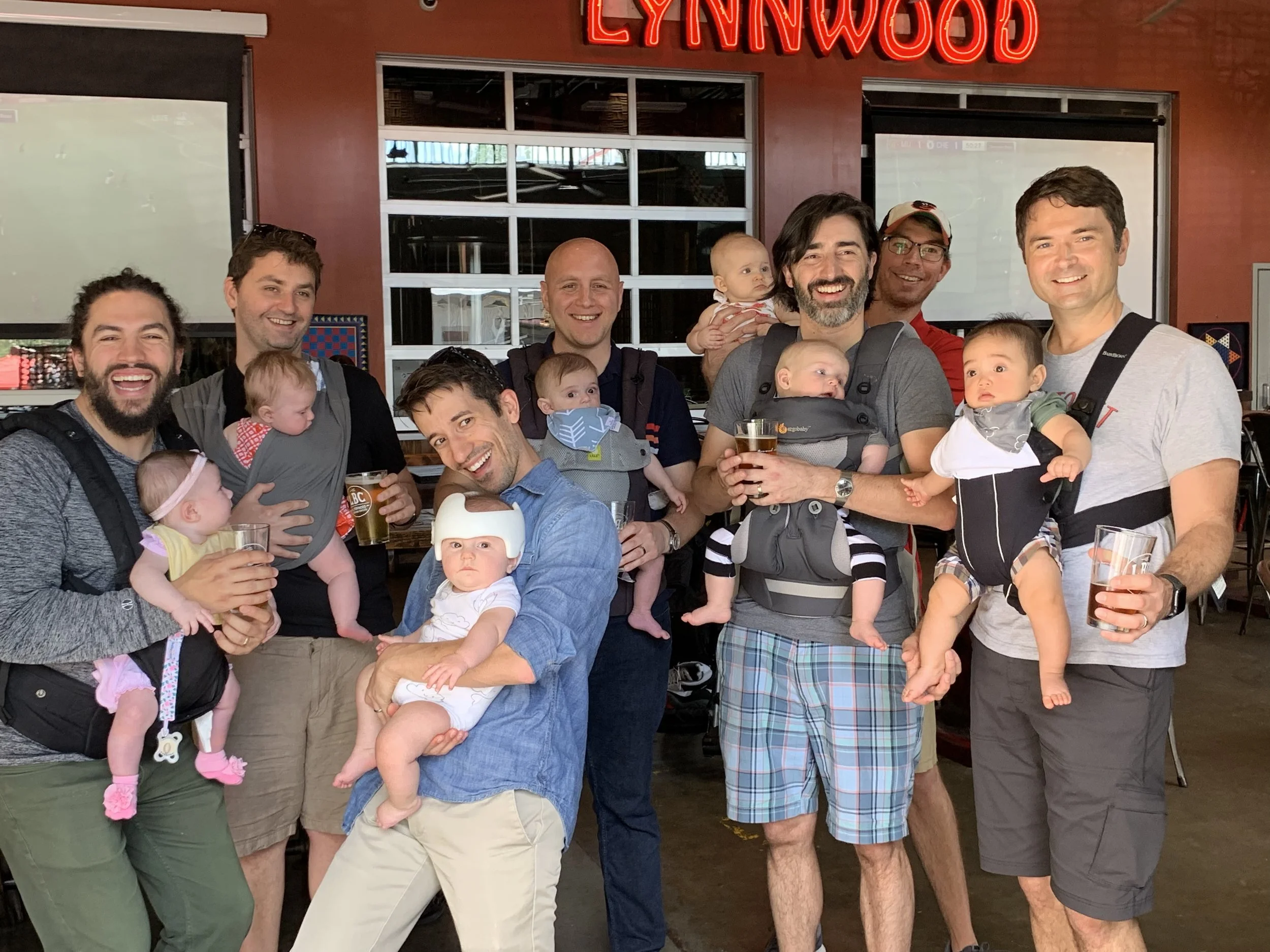 Dads can carry babies too! Adam Ness and Brian Chamberlain with the other Dads from their TAPS group at a recent family outing.