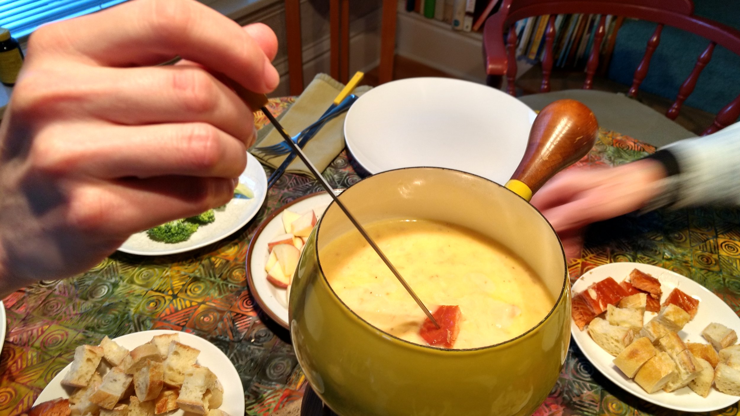 Smoked salmon fondue is to die for! This was the first time we made the recipe and highly recommend it, easy and delicous! Here's our recipe, courtesy of Joanne Monson. 12 oz. Swiss cheese, shredded 8 oz. Gruyere cheese, shredded 1 and 1/2 tsp. cornstarch garlic clove, peeled 1 c. dry sherry 1 tsp. lemon juice 1 package smoked salmon, crumbled dash of ground nutmeg dash of ground pepper bread, apples, vegetables, and one package smoked salmon for dippers In a heavy saucepan over medium heat, combine the cheeses with the cornstarch. Rub the inside of the fondue pot with garlic. Pour in the sherry and lemon juice. Warm till air bubbles rise and cover the surface (do not cover or allow to boil.) From now on, stir constantly. Add a handful of cheeses, keeping heat medium. When melted, toss in another handful. After cheese is melted, add the crumbled smoked salmon and stir until combined. Add a dash of nutmeg and pepper. Transfer to the fondue pot and serve. If it gets too thick, add warmed sauterne.