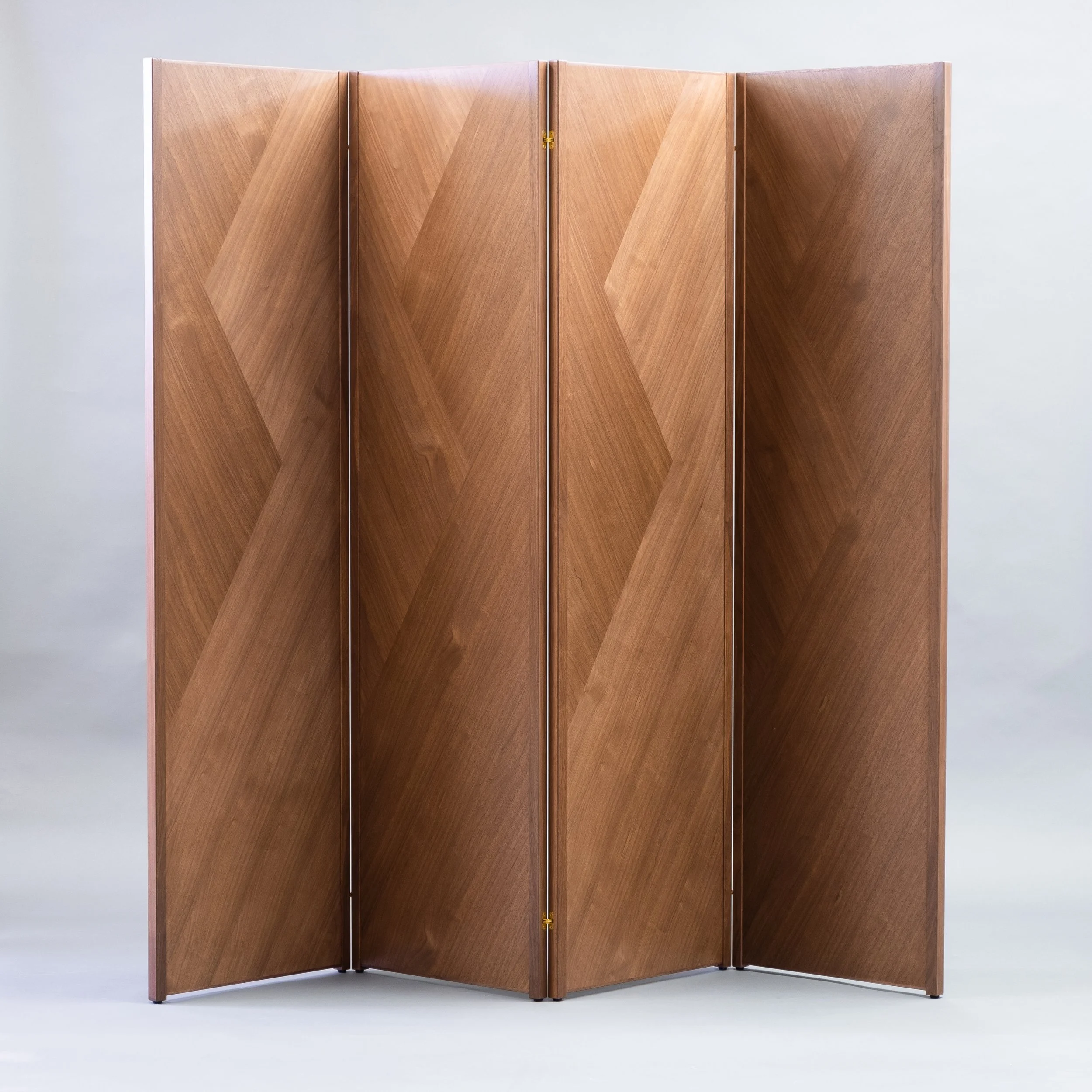 Four-panel folding screen covered an angular pattern of walnut veneer.