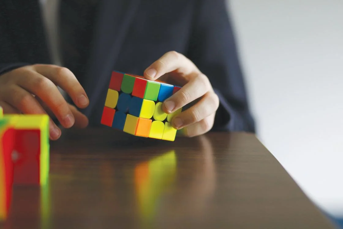 student-hands-cube-puzzle.jpg