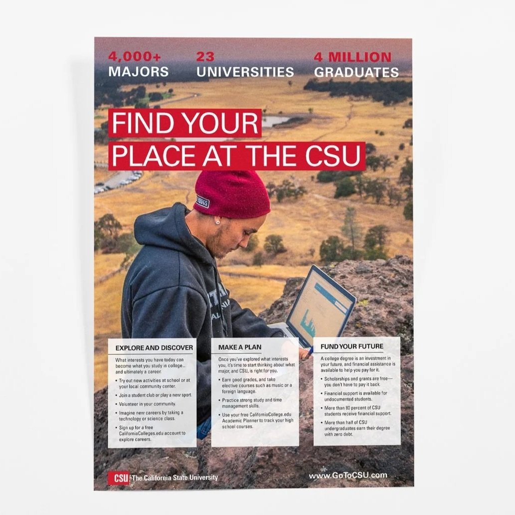 A young man wearing a red beanie and navy hoodie sitting outdoors with a laptop, with a yellow landscape background. Text on the image promotes California State University, listing over 4,000 majors, 23 universities, and 4 million graduates, and encouraging prospective students to find their place at CSU.